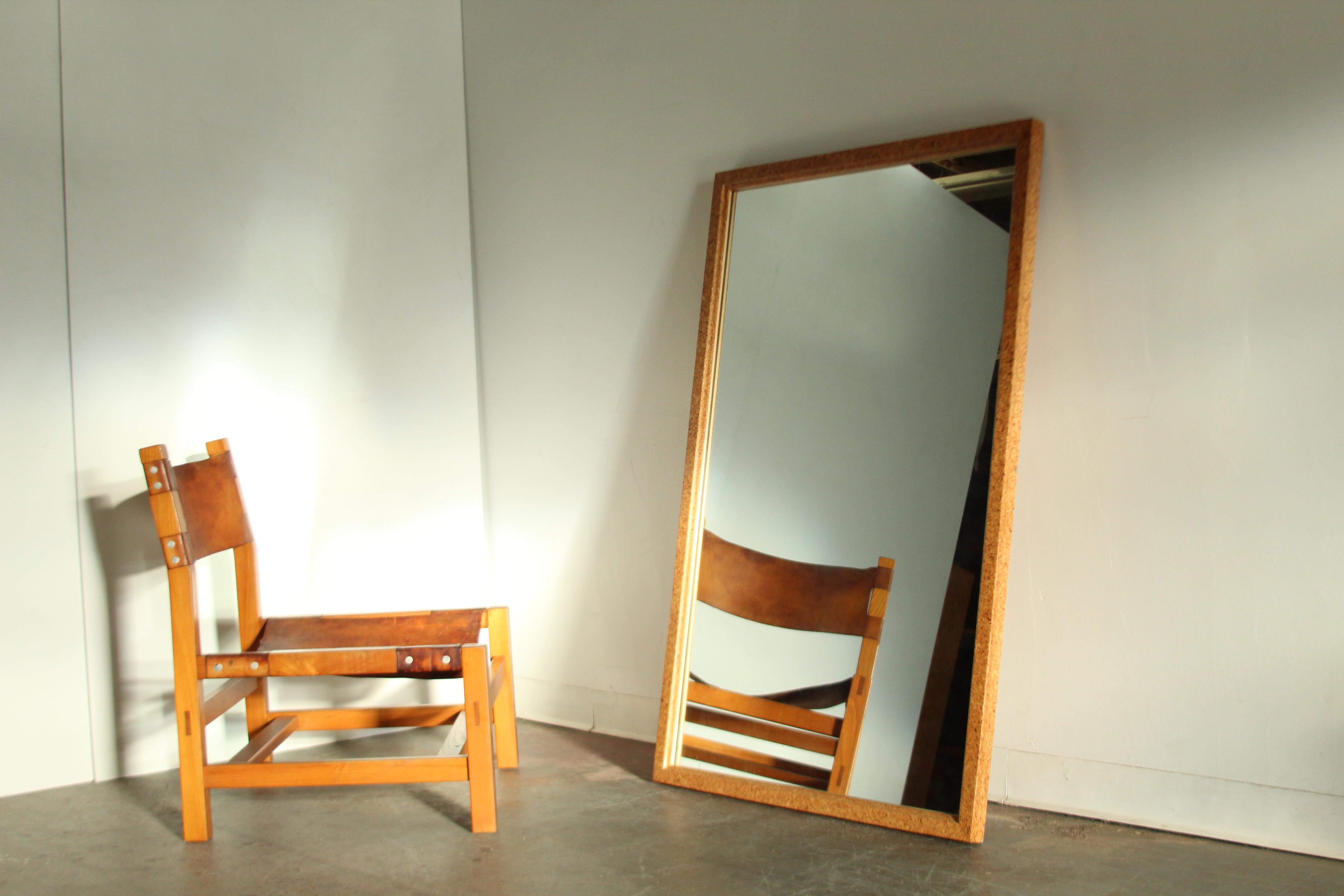 A large and uncommon solid cork mirror designed by Paul Frankl and manufactured by Johnson Furniture in the 1950s. The large piece was intended to be hung on a wall and is equipped with the original horizontal hanging hardware (it could easily be