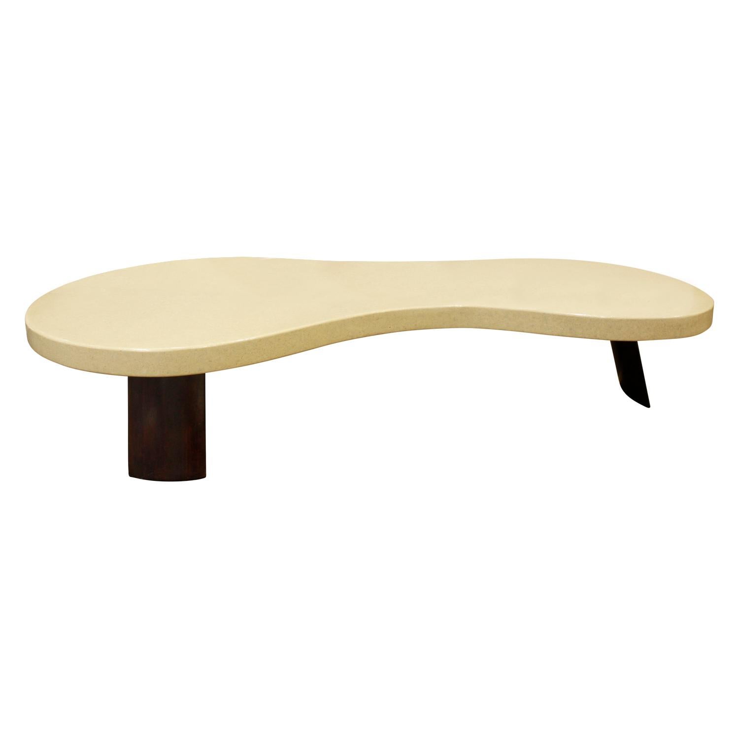 Kidney shaped coffee table with lacquered cork top and canted mahogany slab legs by Paul Frankl for Johnson Furniture, American, 1950s (John Stuart metal label on bottom). This is an iconic Paul Frankl table.