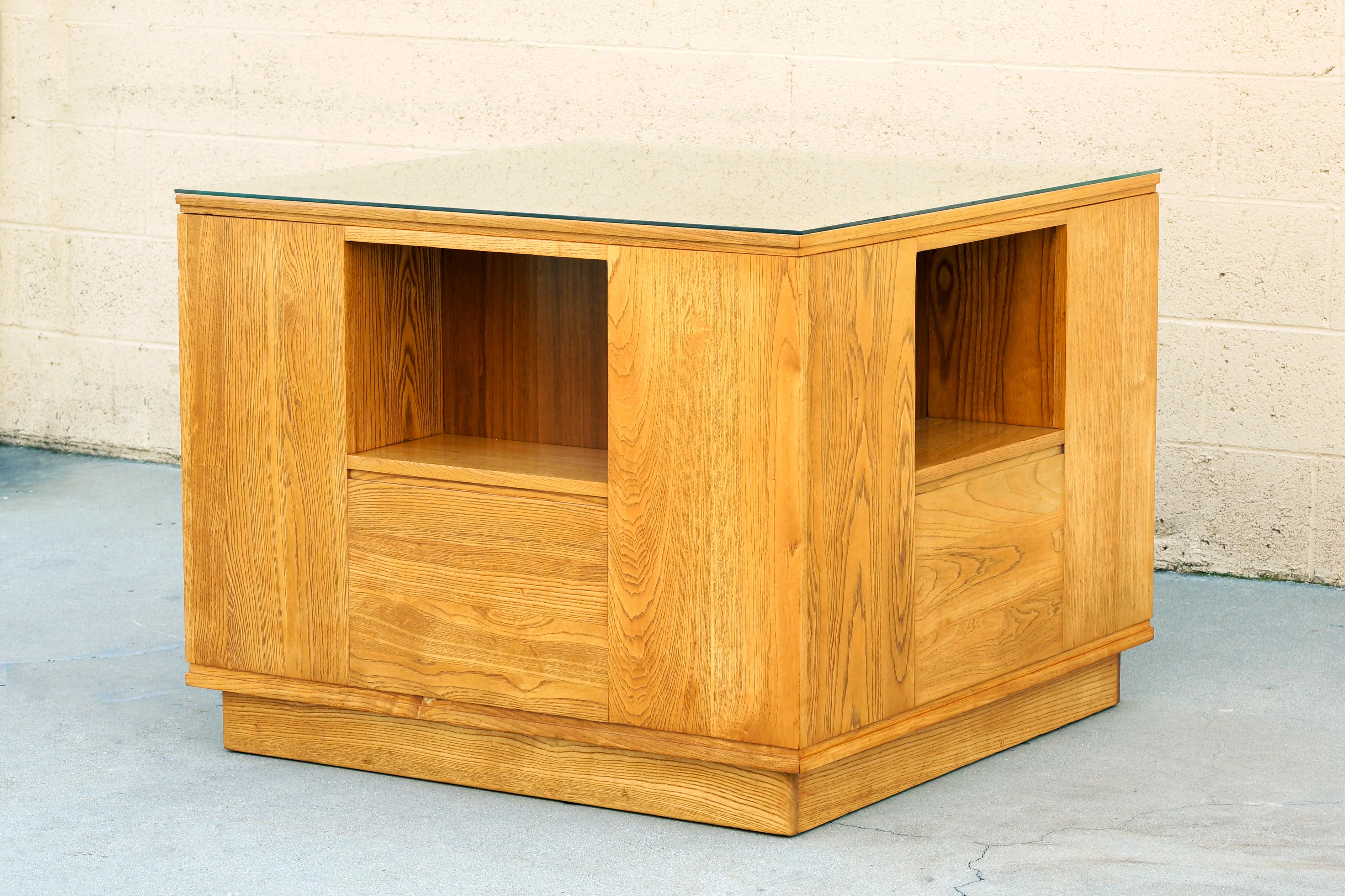 Absolutely wonderful modernist entryway table custom designed by Paul Frankl for a private Los Angeles residence, circa 1940s. Constructed of solid oak with a built-in display alcove on each face. Inset base elevates the cube off the ground.