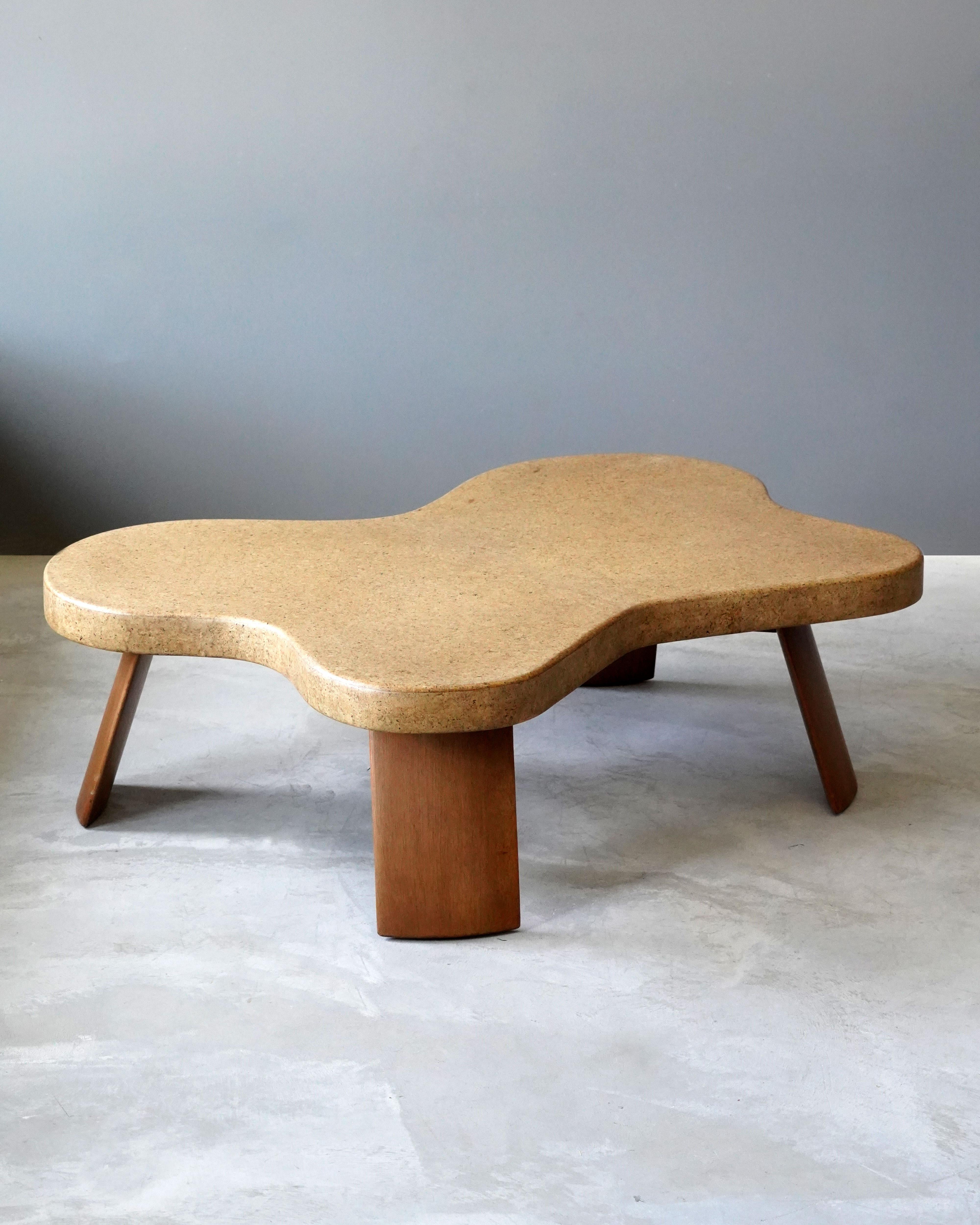 An organic or biomorphic or freeform coffee or cocktail table. Designed by Paul Frankl. Produced by Johnson Furniture Company, early 1950s. Model 5005.

Executed in cork-venered wood top, stained mahogany legs. 
 
Other designers working in the