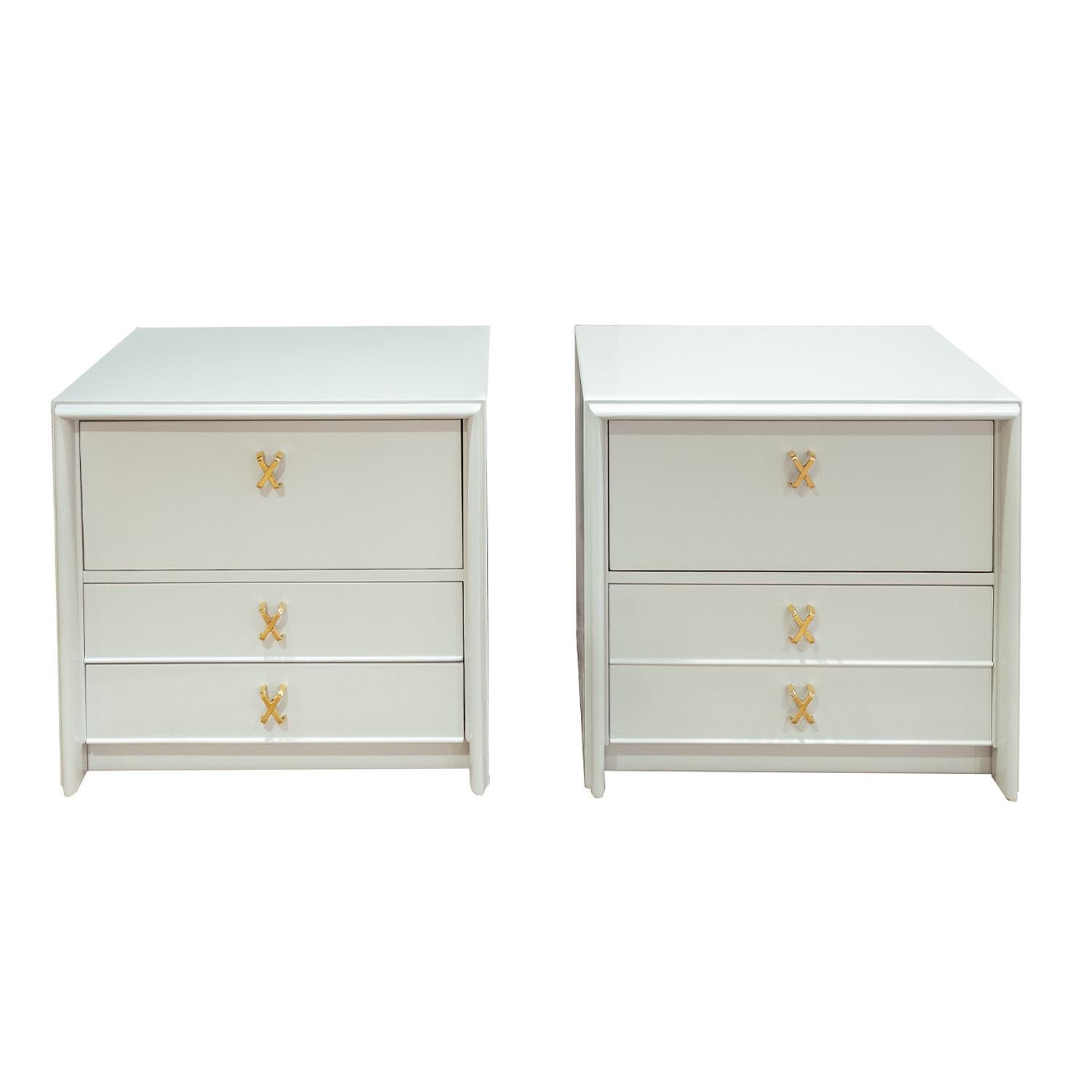 Pair of elegant bedside tables in pale gray with a hint of blue lacquer with polished brass X pulls by Paul Frankl for Johnson Furniture, American 1950's (signed “Johnson Furniture co. Grand Rapids Mich.” inside drawer). These have been completely