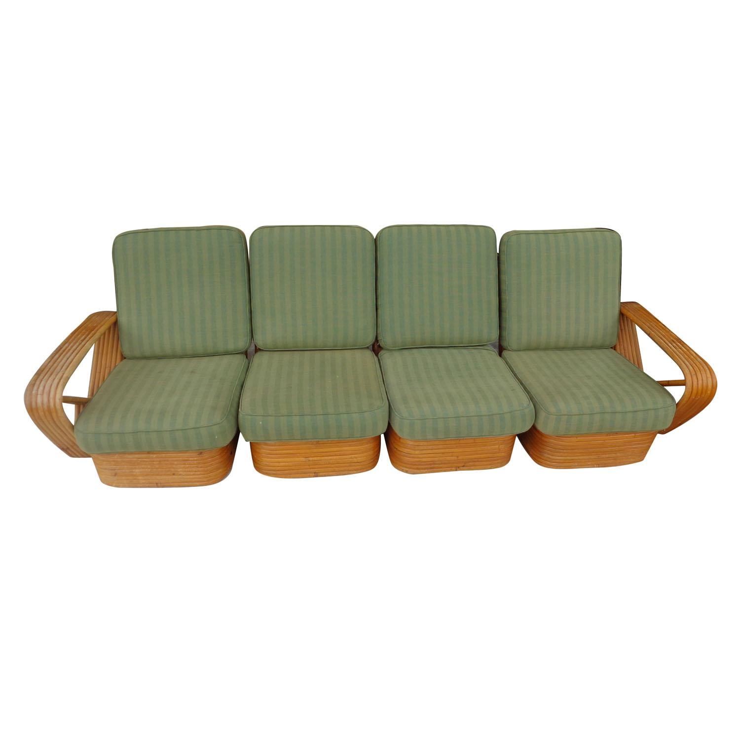 Paul Frankl Pretzel 4-seat rattan bamboo sofa.

Rare 4 seat version this classic design. Pretzel rattan sectional sofa designed by Paul Frankl. This sofa features a stacked rattan base with six strand square pretzel arms and is divided into a four