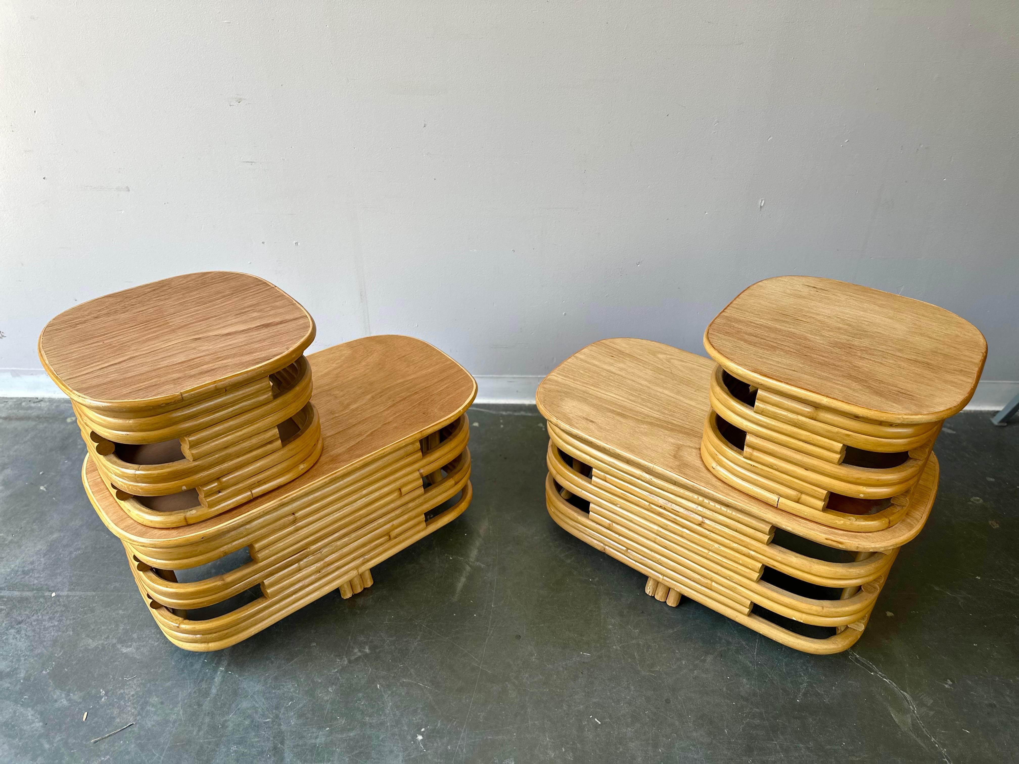 Lovely pair of stacked rattan side tables in the manner of acclaimed deco designer Paul Frankl, circa 1940s. In very good vintage condition.

Dimensions: 32” W x 15.5” D x 21.5” H.
