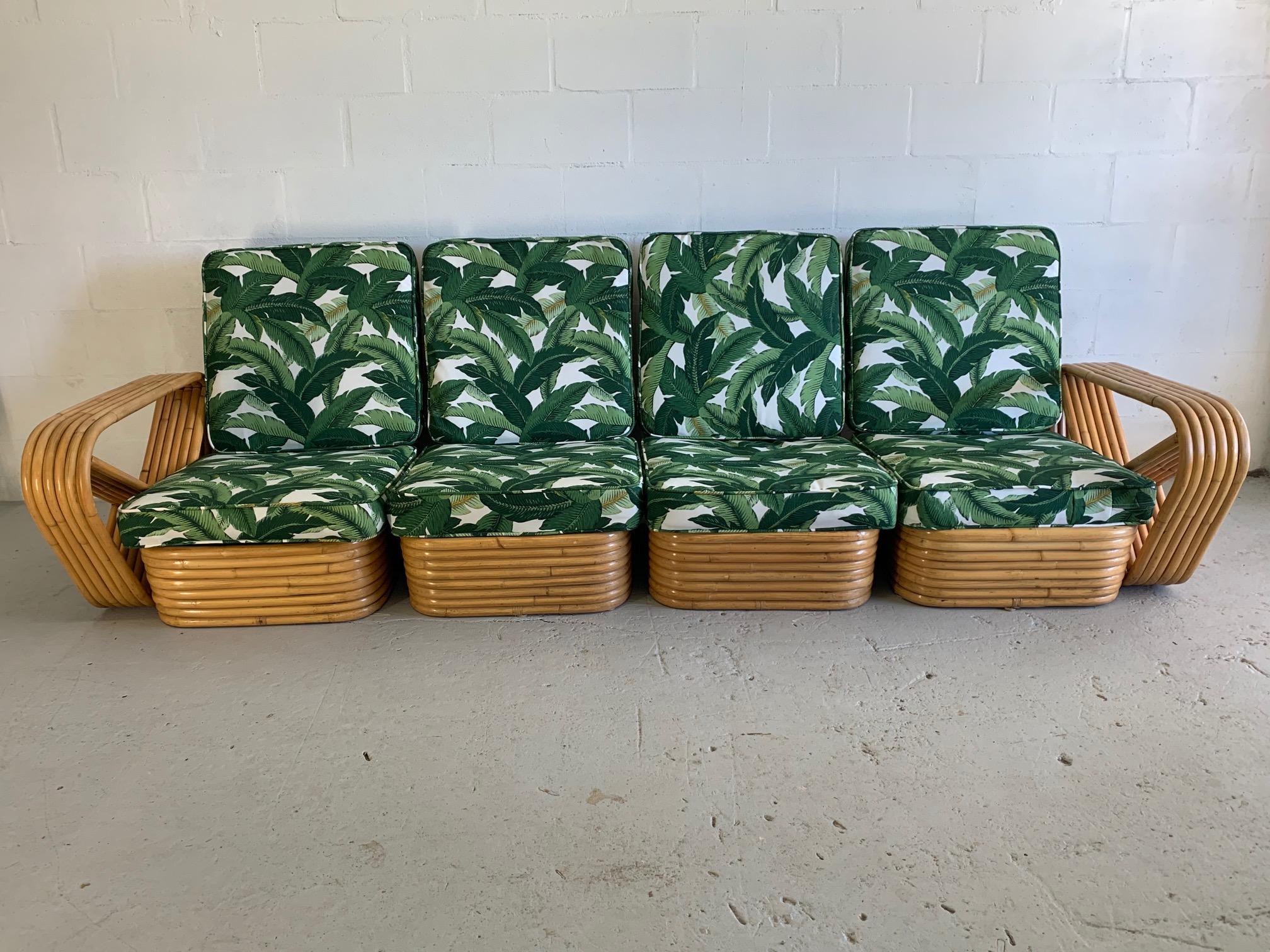 Four-piece modular rattan pretzel style pretzel sofa features 6-strand frame and newly upholstered tropical palm leaf fabric. Reminiscent of styles from Paul Frankl and others. Very good condition both structurally and cosmetically with minor
