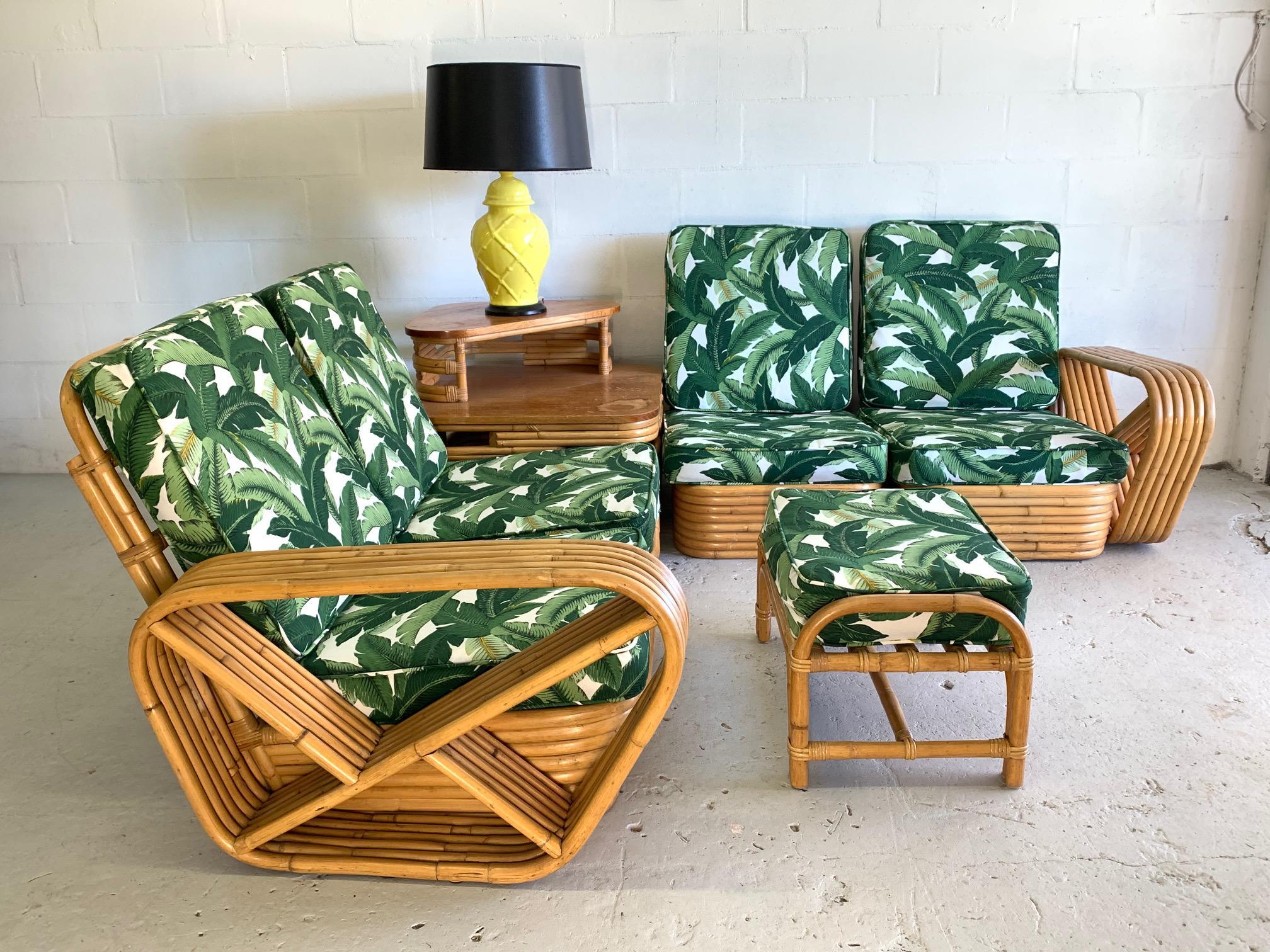 Four piece modular rattan Paul Frankl style pretzel sofa features 6-strand frame and newly upholstered tropical palm leaf fabric. Very good condition both structurally and cosmetically with minor imperfections consistent with age. Can be arranged