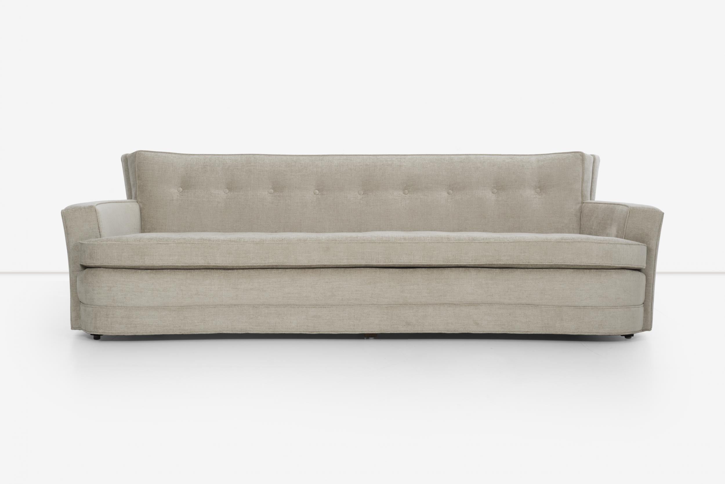 Paul Frankl style sofa 100 inche length, extreme curved arms, slightly curved back details.
Reupholstered with great plains cotton-poly.
Button tufted back and seat with loose cushion.
