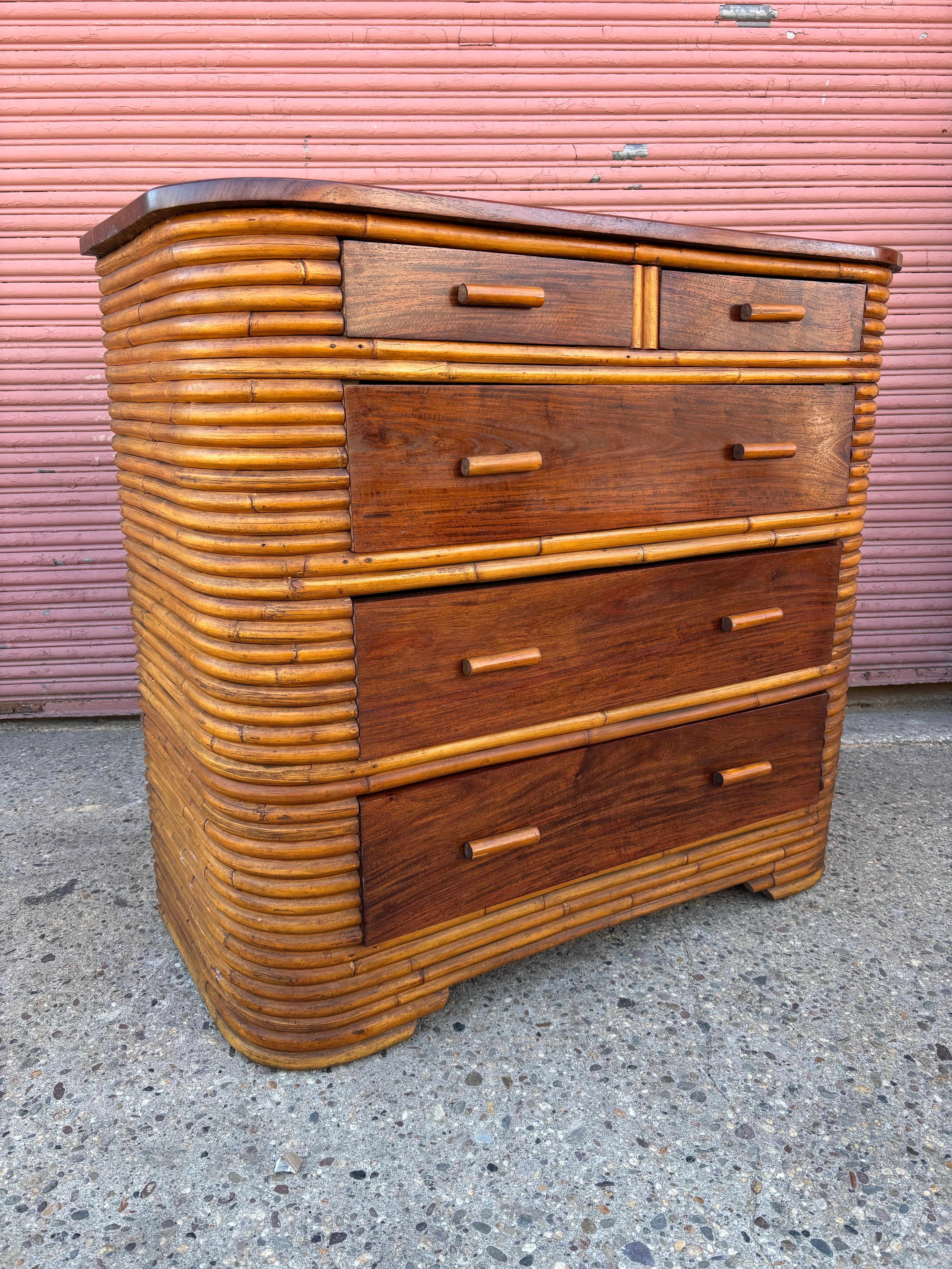 Bamboo and solid Mahogany 5 Drawer Dresser.  All mahogany has been refinished and bamboo cleaned.  Patina on bamboo is very nice.  Dresser is finished in bamboo on backside as well.  All drawer tracks have been worked on so drawers pull out easily