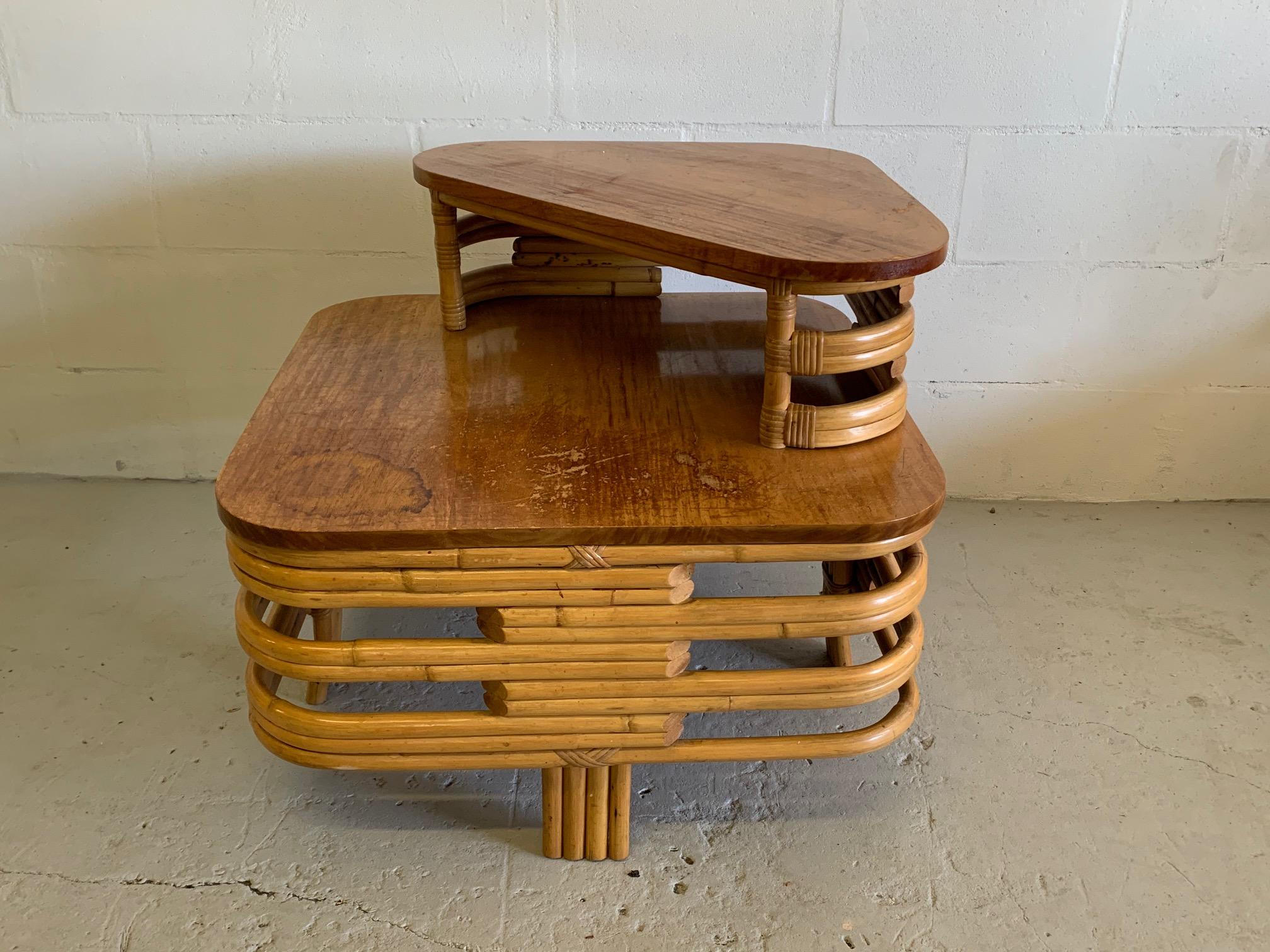 Art deco two-tiered stacked rattan side table in Paul Frankl style features bent rattan and mahogany top. 
 In good condition save for one area of stain at corner. Structurally very sound. Features four-strand legs at each side.  T1234