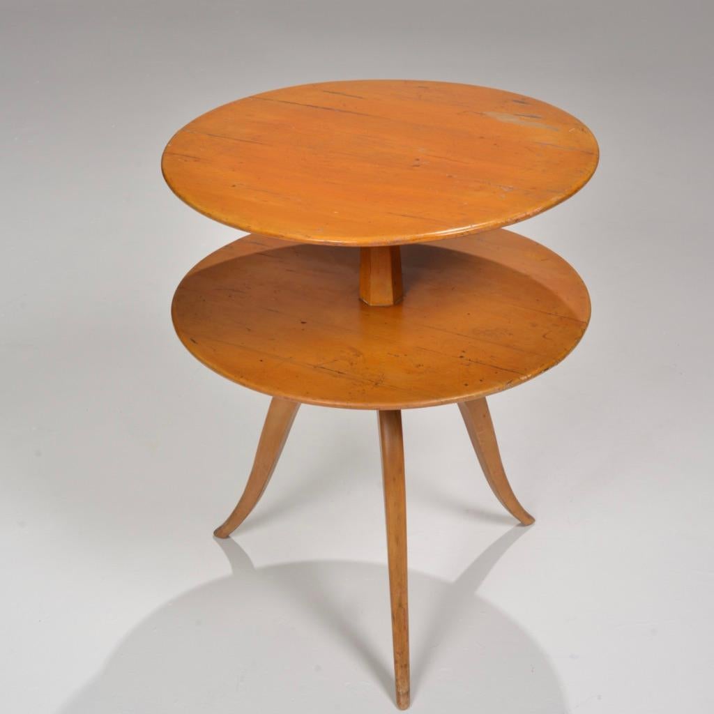 Paul Frankl two-tiered occasional table by Brown Saltman of California, circa 1950. 
Solidly crafted and elegantly designed. 
Signed and marked. 
We have not refinished or restored this table. Please inquire for refinishing rates.