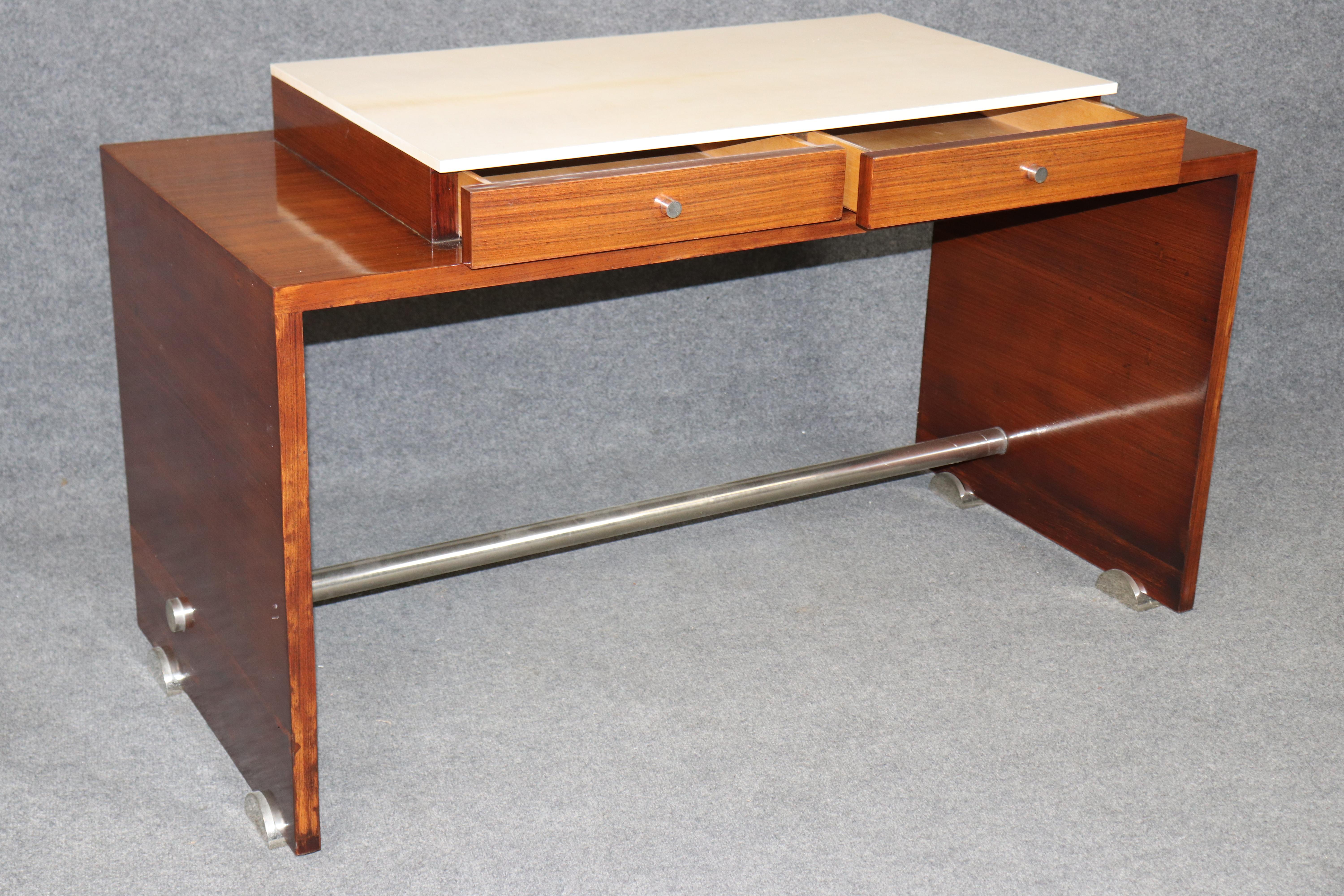 This striking Italian-made console table captures the bold geometry and luxurious material vocabulary of classic Art Deco design, interpreted with a clean, modern sensitivity. Crafted with a richly figured rosewood frame, the piece showcases the