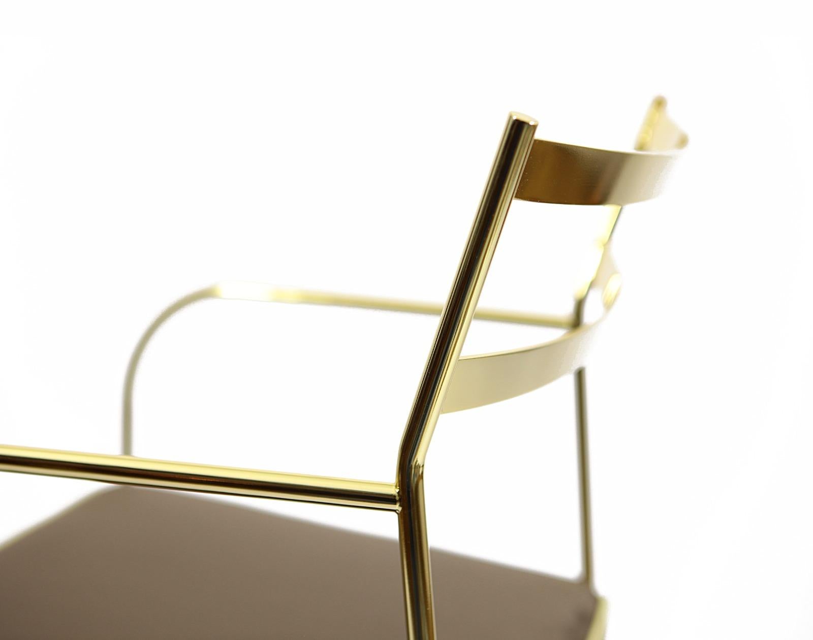 This unique chair has an iron structure covered with a 24-karat gold flash plating, and elegant galvanized brass feet.  The seats are covered in cotton velvet  and decorated with an elegant yellow piping all around the edges