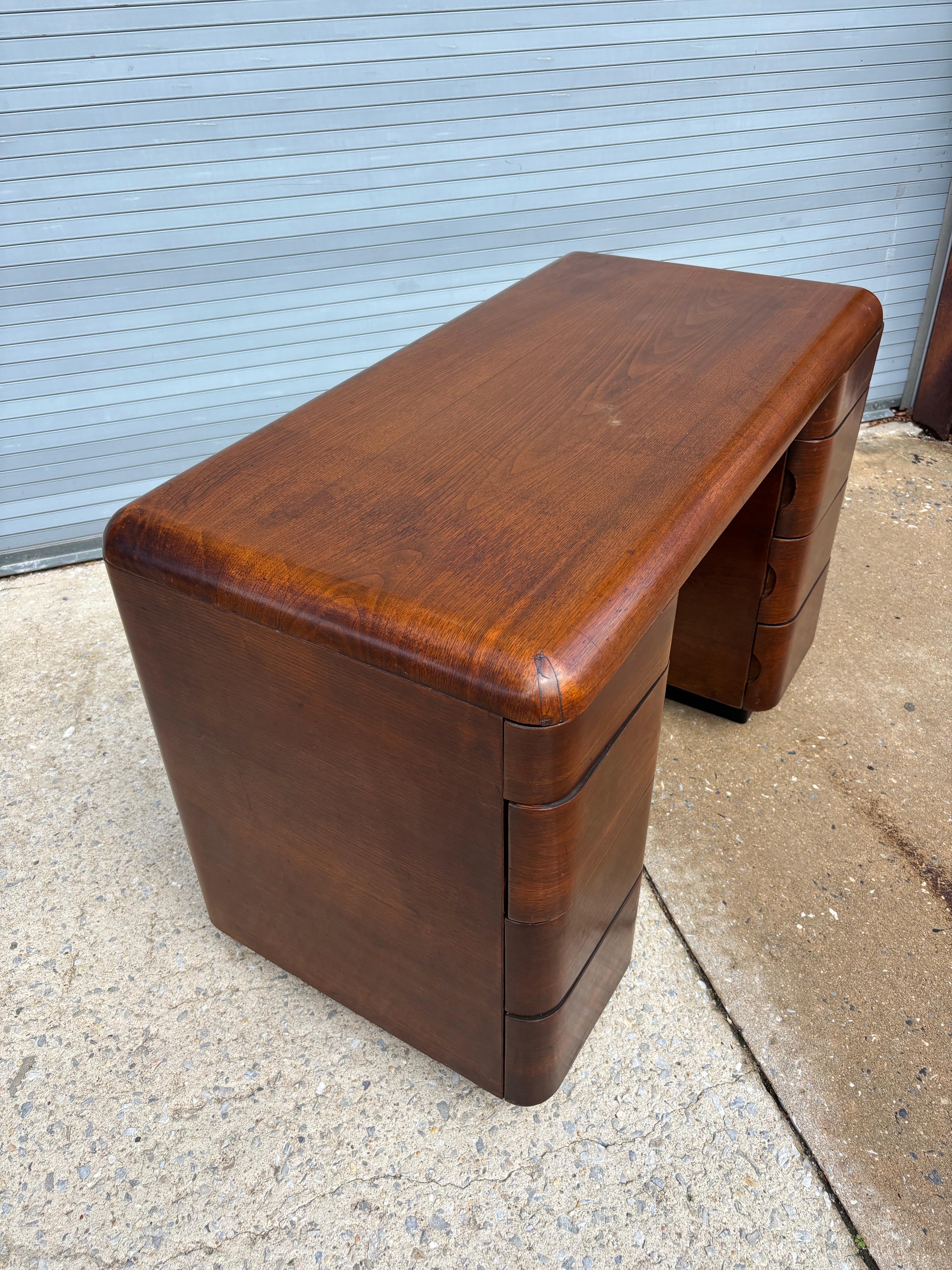 Paul Goldman for Plymodern Molded Plywood Desk.  Plymodern developed several designs all made of plywood.  There is a bedroom grouping as well that you see sometimes.  The desk maybe turns up the most but overall not a lot of it out there.  Unusual
