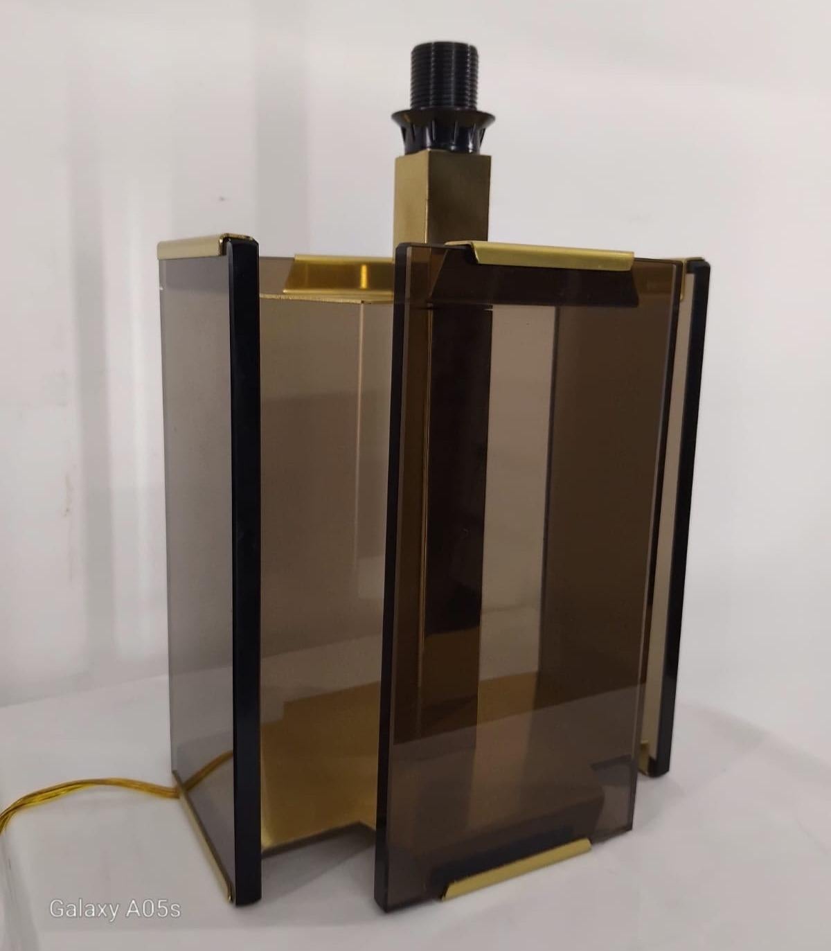 Table lamp from the 70s/80s signed, brass and smoked glass in very good condition and perfectly working. 
The lamps were not in use. Unuserd , some in original packing. 
Availability 6 pcs Height 33 cm width 22 x 16 cm.