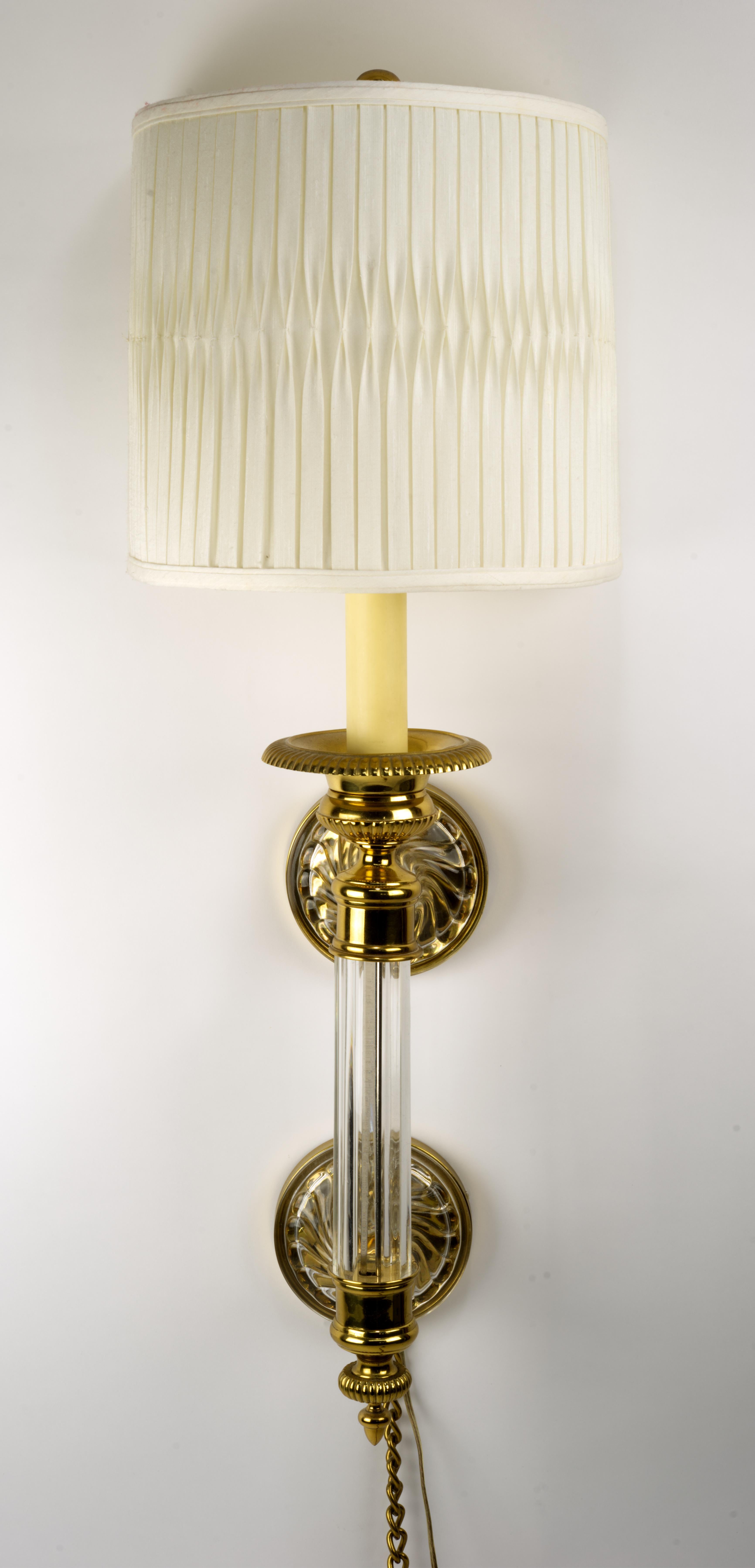 Very nice Paul Hanson wall mounted sconce. Brass is evenly patinated.  No dents are present. Cut crystal is gorgeous.  It's in a very good shape. No chips or fleabites. Shade has a tear on the inside underlayment. Outside is clean.
This sconce could