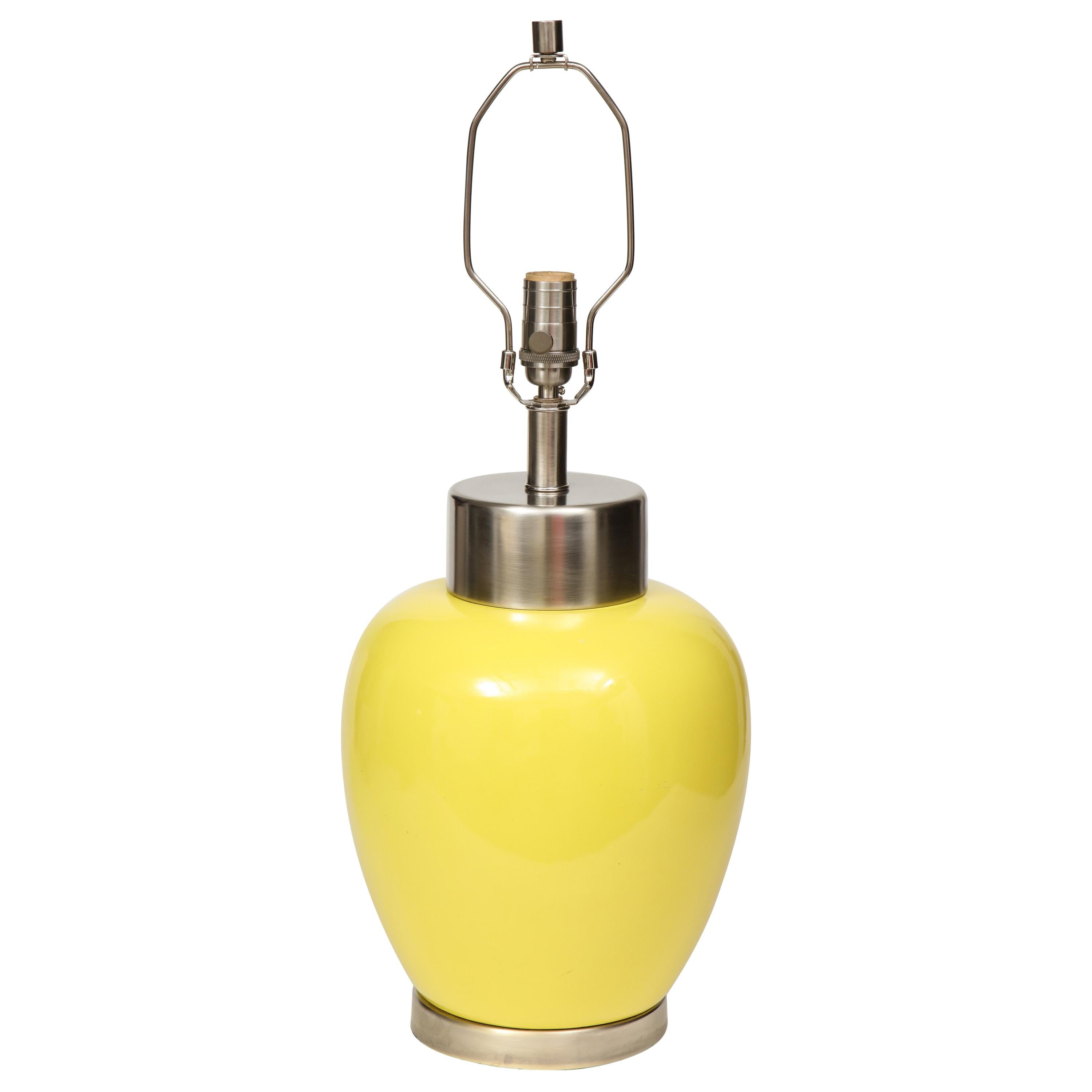 Pair of midcentury porcelain lamps with a lemon yellow glaze and brushed nickel hardware. 100W max bulbs. Rewired for use in USA.