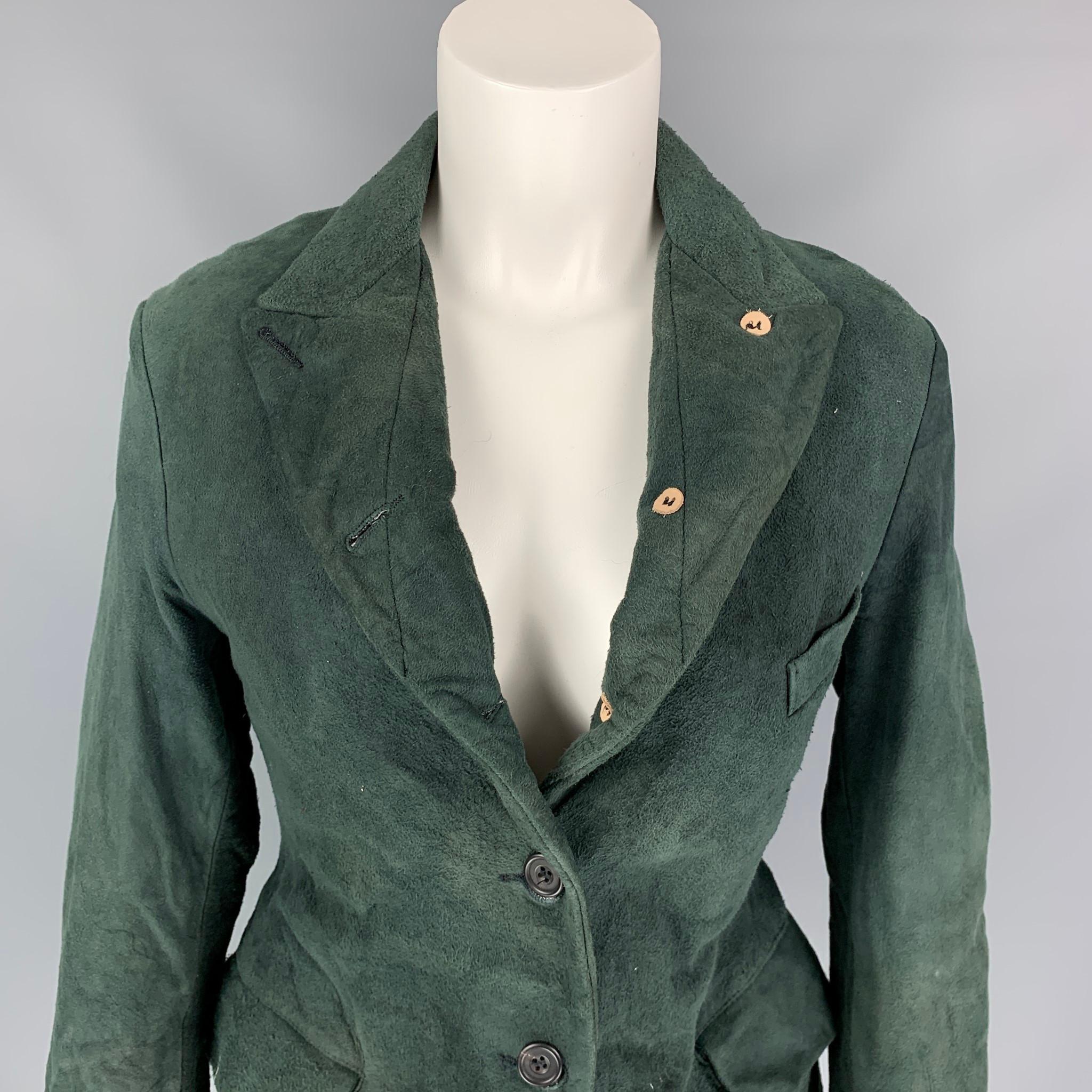 PAUL HARNDEN jacket comes in a green boiled suede with a full liner featuring a peak lapel, flap pockets, and a two button closure. Made in England.

Very Good Pre-Owned Condition.
Marked: M

Measurements:

Shoulder: 17 in.
Bust: 34 in.
Sleeve: 23.5
