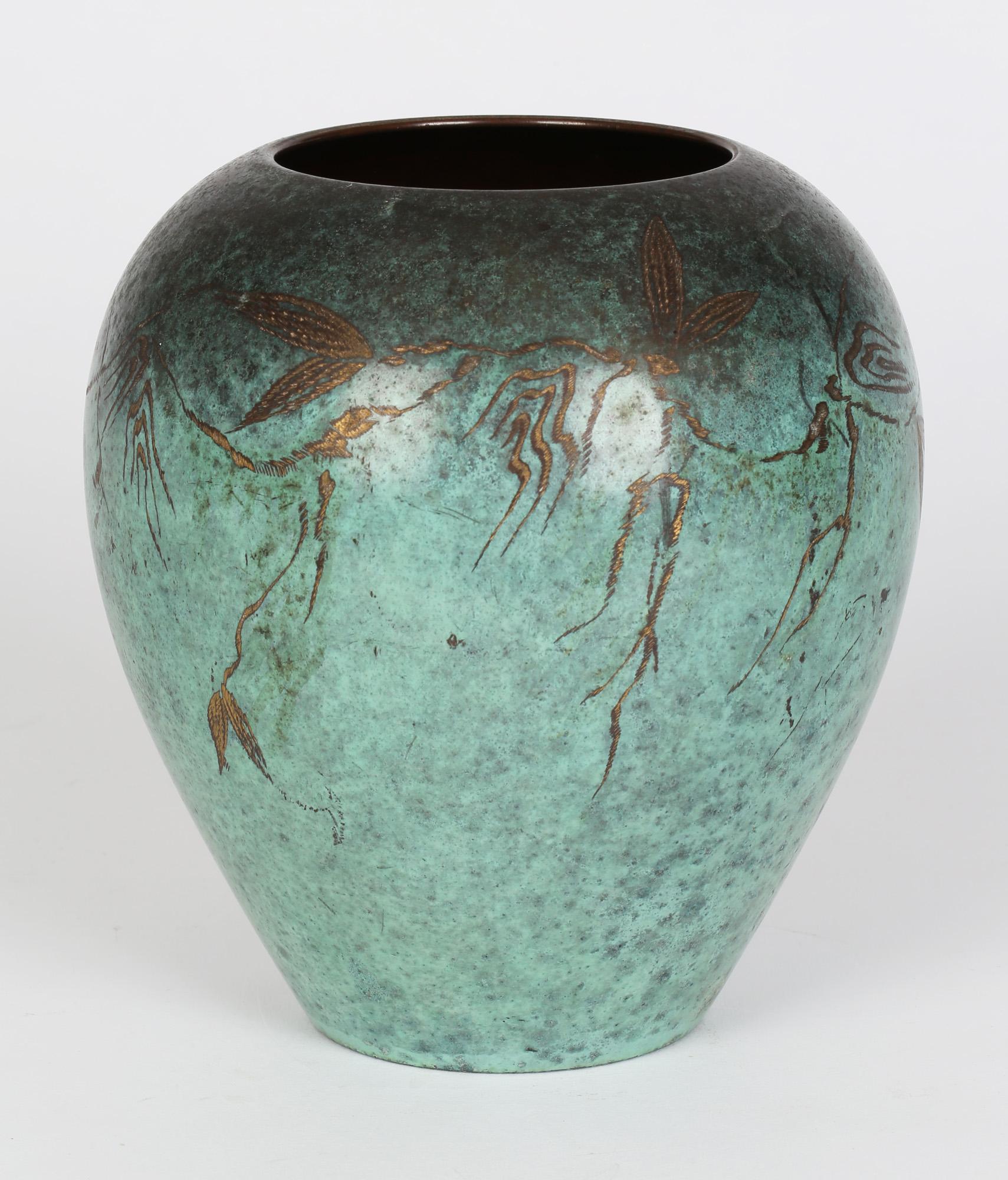 A fine WMF (Württembergische Metallwarenfabrik) patinated bronze Ikora vase decorated with a stylized trailing leaf designs by Paul Haustein (1880-1944) and dating from around 1920. This rounded bulbous shaped vase stands on a narrow rounded foot
