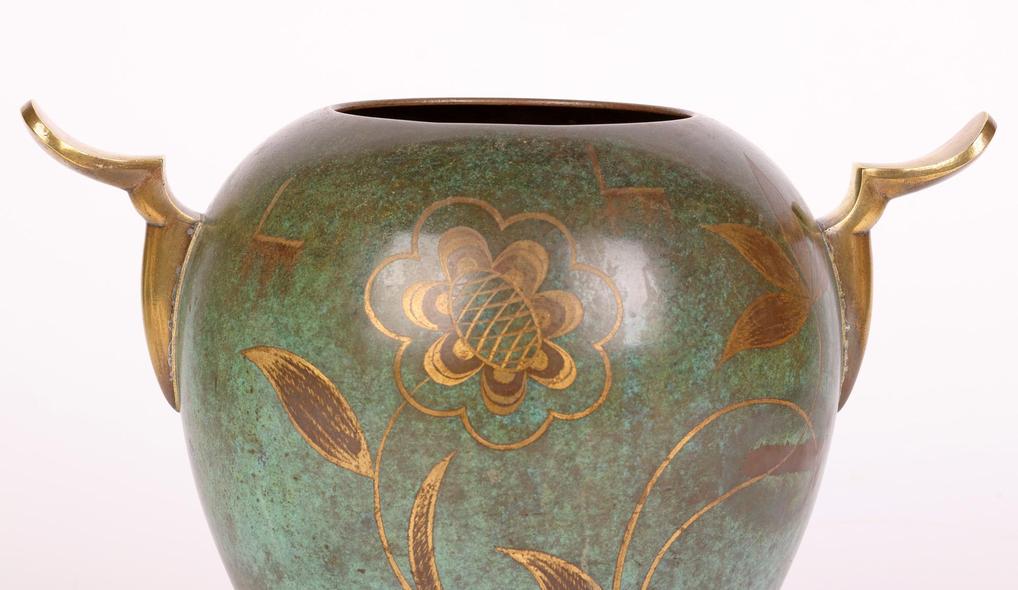 A very fine and stylish Art Deco WMF (Württembergische Metallwarenfabrik) patinated bronze twin handled Ikora vase decorated with stylized floral designs by Paul Haustein (1880-1944) and dating from around 1920. This elegantly shaped vase stands on