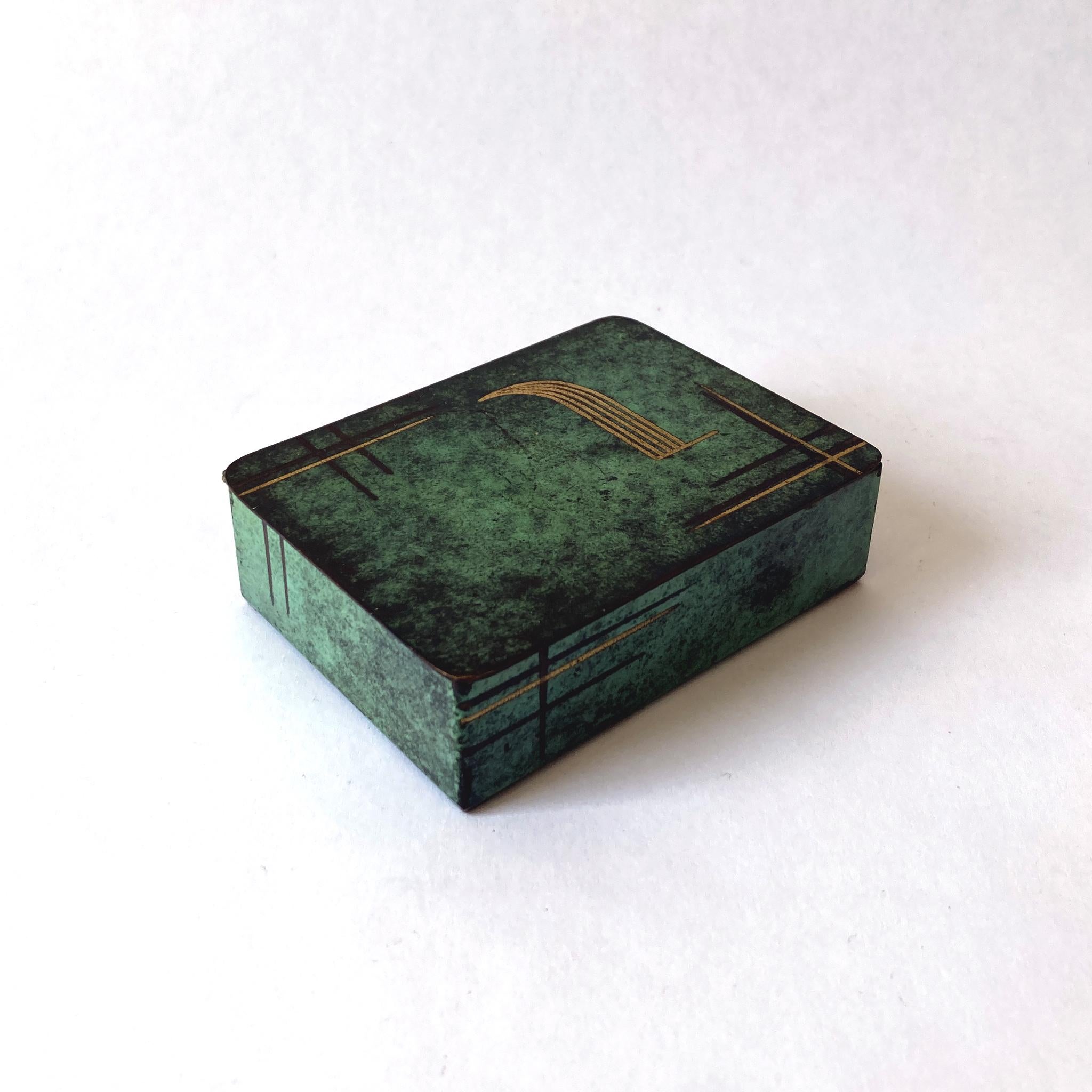 Rare Paul Haustein, WMF Ikora metal hinged box, wood-lined. The patinated green metal contrasts beautifully with the etched gold and dark brown pattern seen on the lid and sides. This piece looks wonderful as part of a group, or independently on a