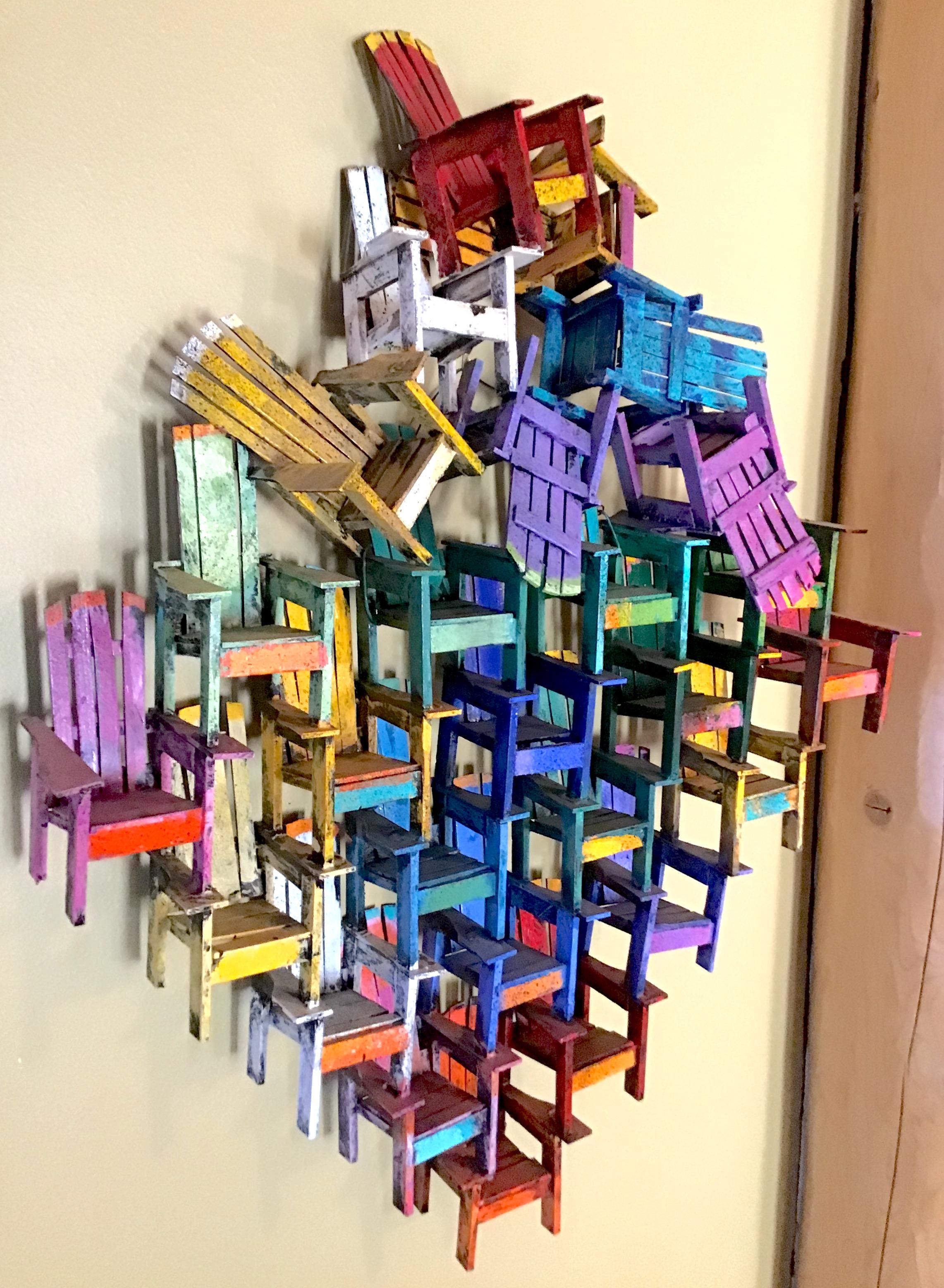 Colorful Adirondack chair wall sculpture

Paul Jacobsen used everyday objects, such as chairs, cars, airplanes, trains, motorcycles and puzzles, all built from scratch, and turns them into very desirable works of art. Among his most famous works are