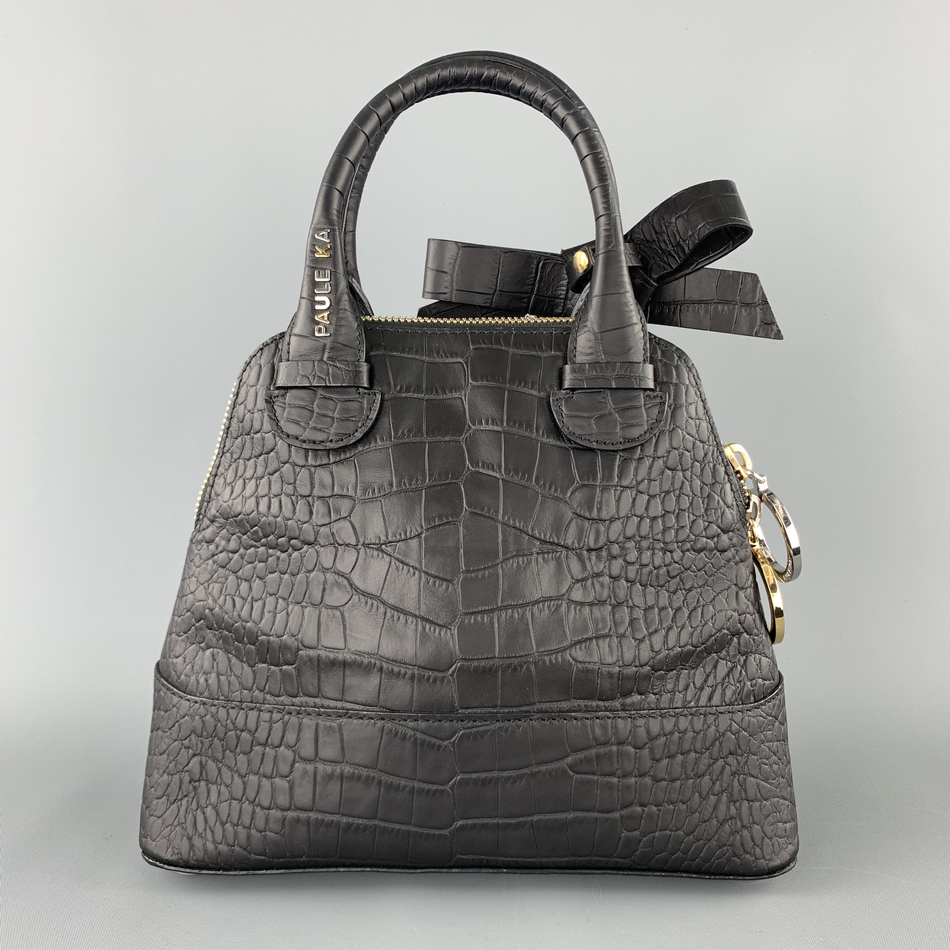 PAUL KA handbag comes in crocodile embossed leather with a double rolled top handle, dual tone zip closure, and snap bow accent. 
 

Excellent Pre-Owned Condition.

Measurements:

Length: 10 in.
Width: 3.75 in.
Height: 8 in. 
