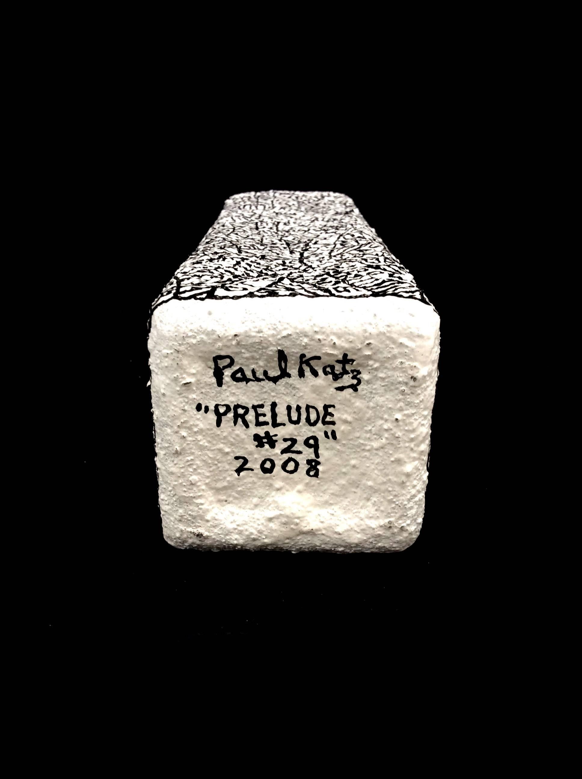 Plaster, sand, & paint on found object
11 x 2.25 x 2.25 inches

This black and white sculpture was created by Hudson Valley-based artist Paul Katz, whose process involves coating found objects in plaster, sand, & paint. The inscription which coats