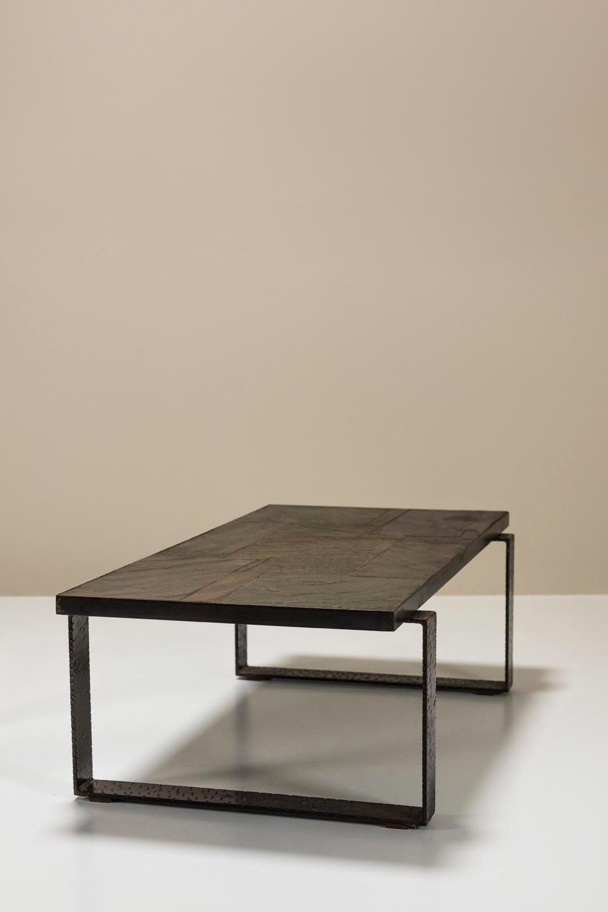 Paul Kingma brutalist coffee table in stone and hammered metal. The rough look and feel of this table is a typical trademark of the Dutch sculptor, mosaic artist, painter and draftsman Paul Kingma. In the early 1960s he started making these types of