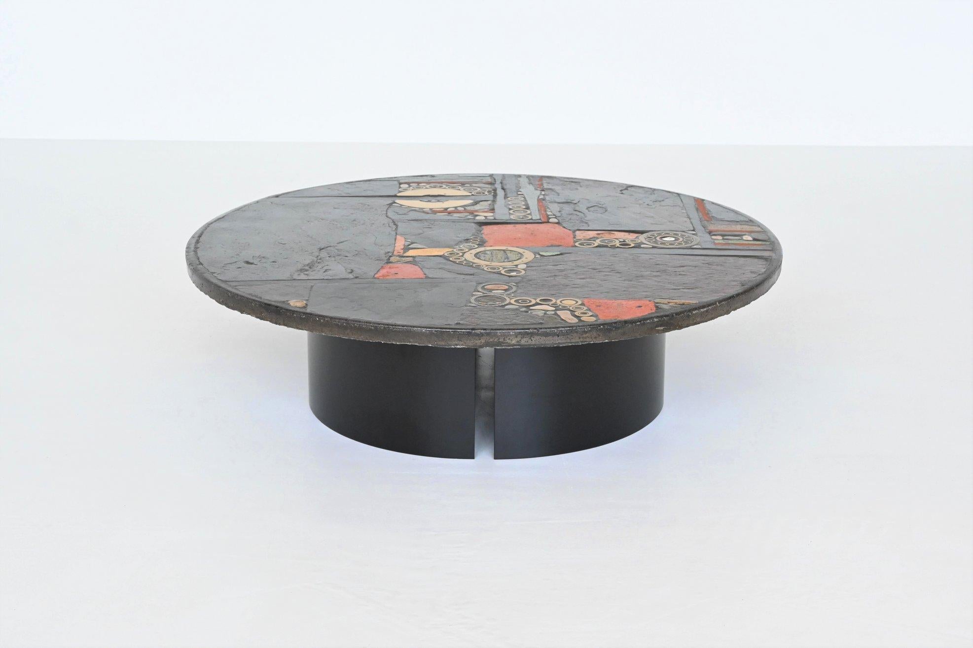 Beautiful large round shaped coffee table designed and made by Paul Kingma, The Netherlands 1979. The heavy concrete top rests on a base of two black coated half circles that can be placed in several positions. Beautiful composition of slate,