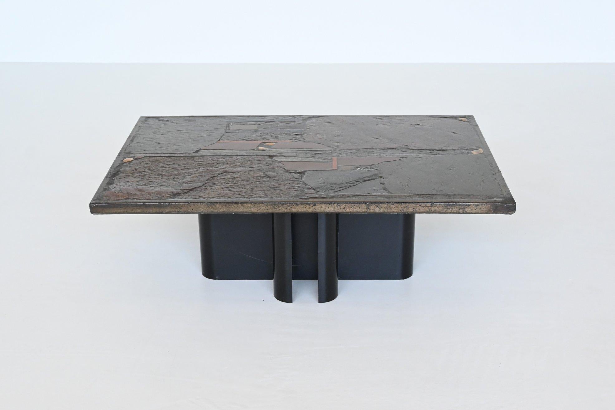 Beautiful rectangular shaped brutalist coffee table designed and made by Paul Kingma, The Netherlands 1970. The heavy concrete top rests on a black lacquered metal base. Beautiful composition of slate, stones, copper and brass makes this table a