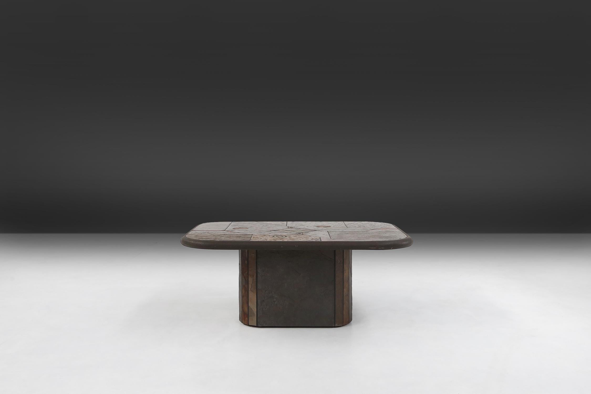 Coffee table made an designed by the dutch artist Paul Kingma.
All of his coffee tables he hand made with materials he gathered during his travels around the world, are now being considered as highly collectible.
Made of slate stone, brass details
