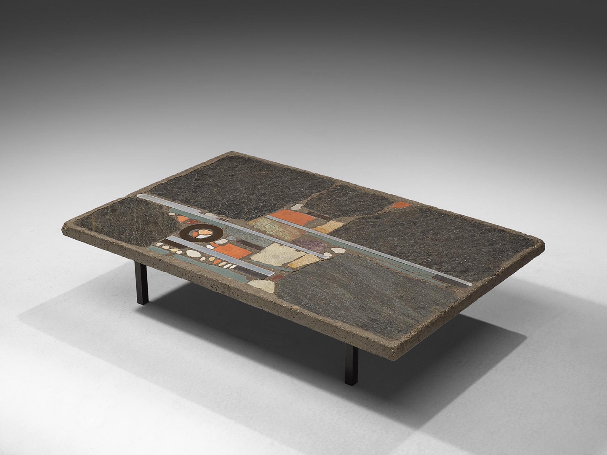 Paul Kingma, slate and ceramic tile coffee table, the Netherlands, 1980s. 

Abstract design of metals, slate and other stones, set into concrete panel. The different materials create a beautiful and organic mosaic. Paul Kingma was a Dutch
