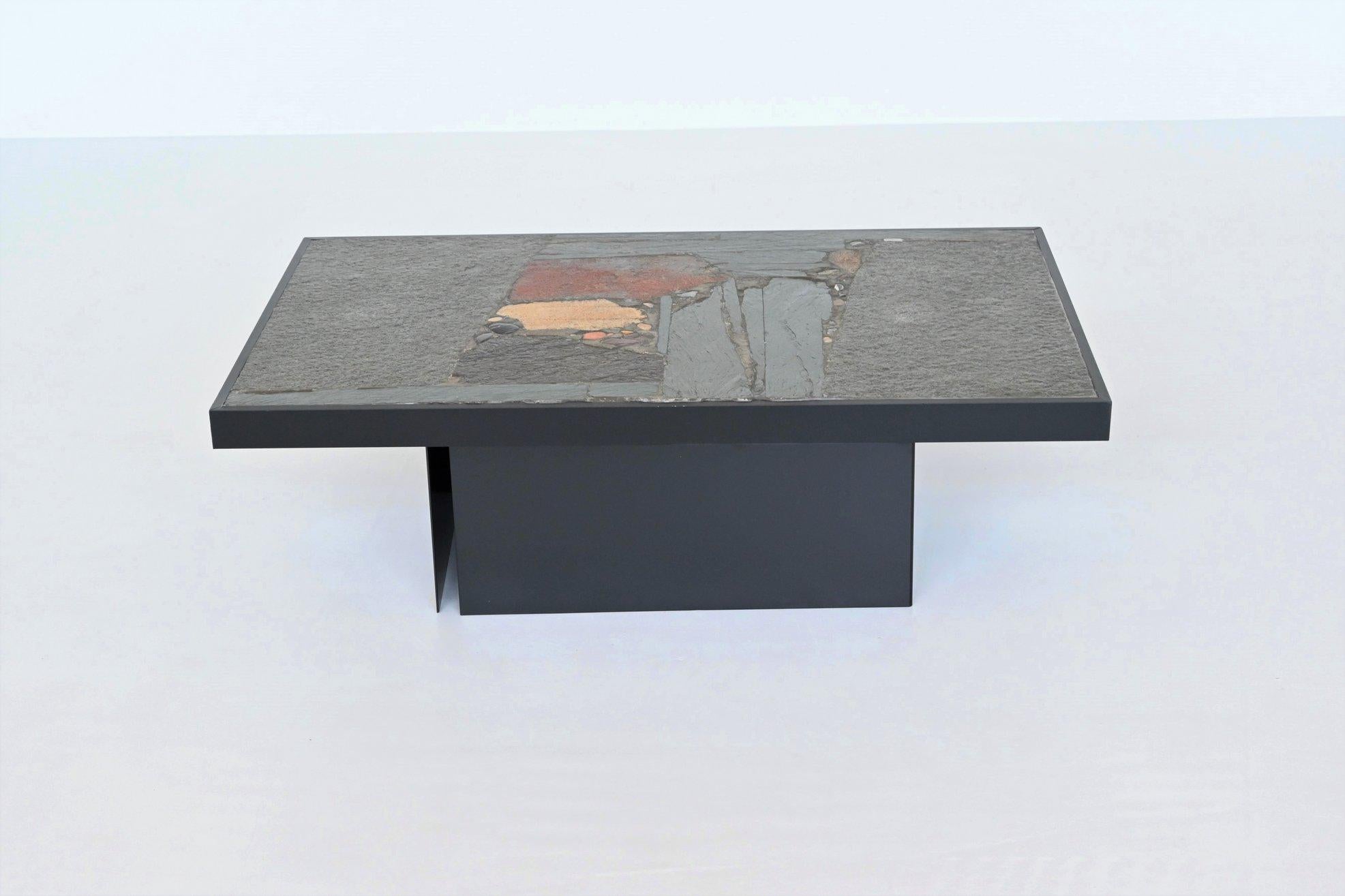 Beautiful rectangular shaped coffee table designed and made by Paul Kingma, The Netherlands 1970. The heavy concrete top rests on a base of two black lacquered metal bases that can be placed in several positions. Beautiful composition of slate,