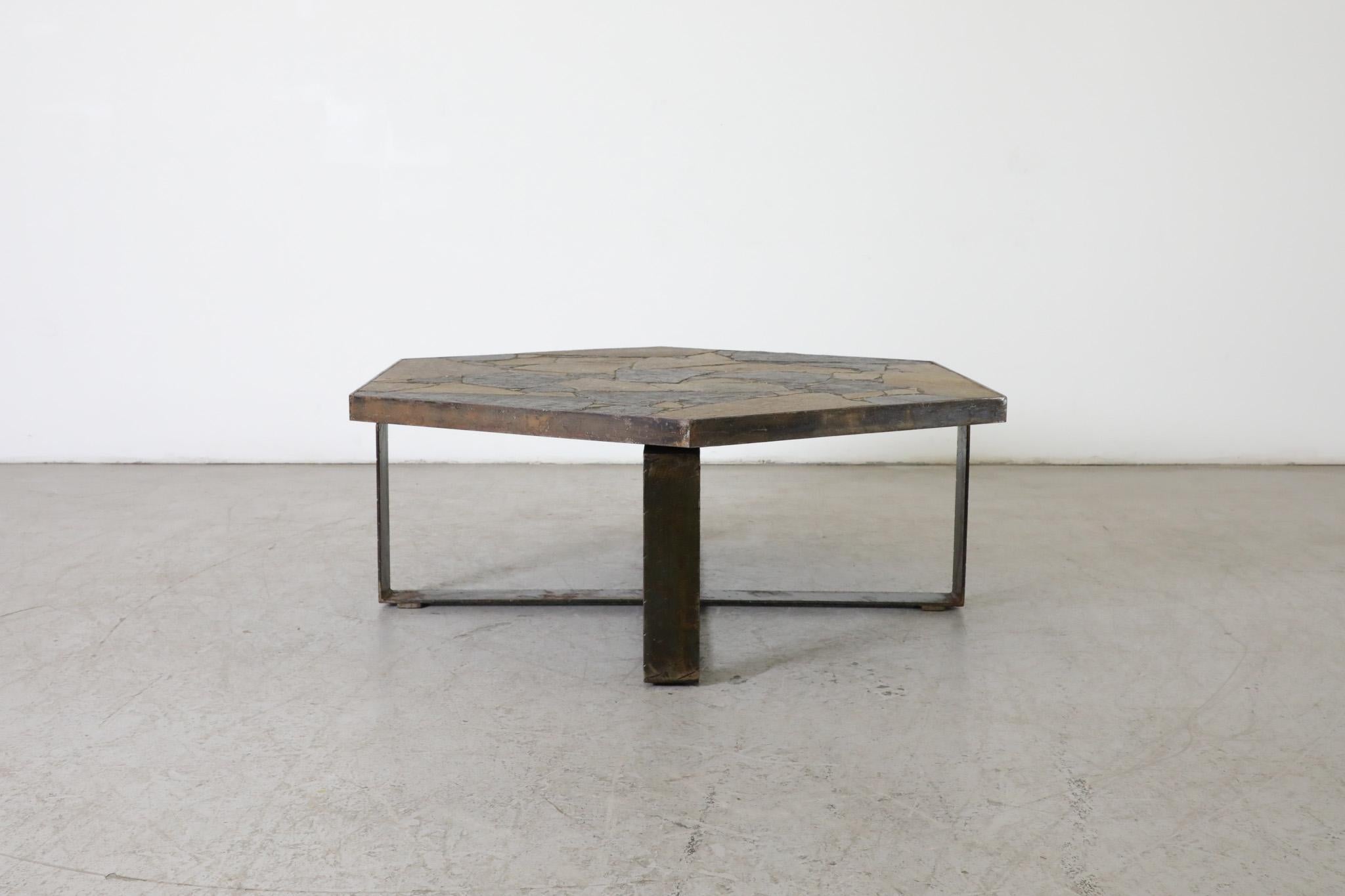 Innovative Dutch designer Paul Kingma is credited with creating this style of Mid-Century coffee table made of concrete, slate, and glacial stone. In this excellent Brutalist and architectural example, a thick steel frame supports an hexagonal top,