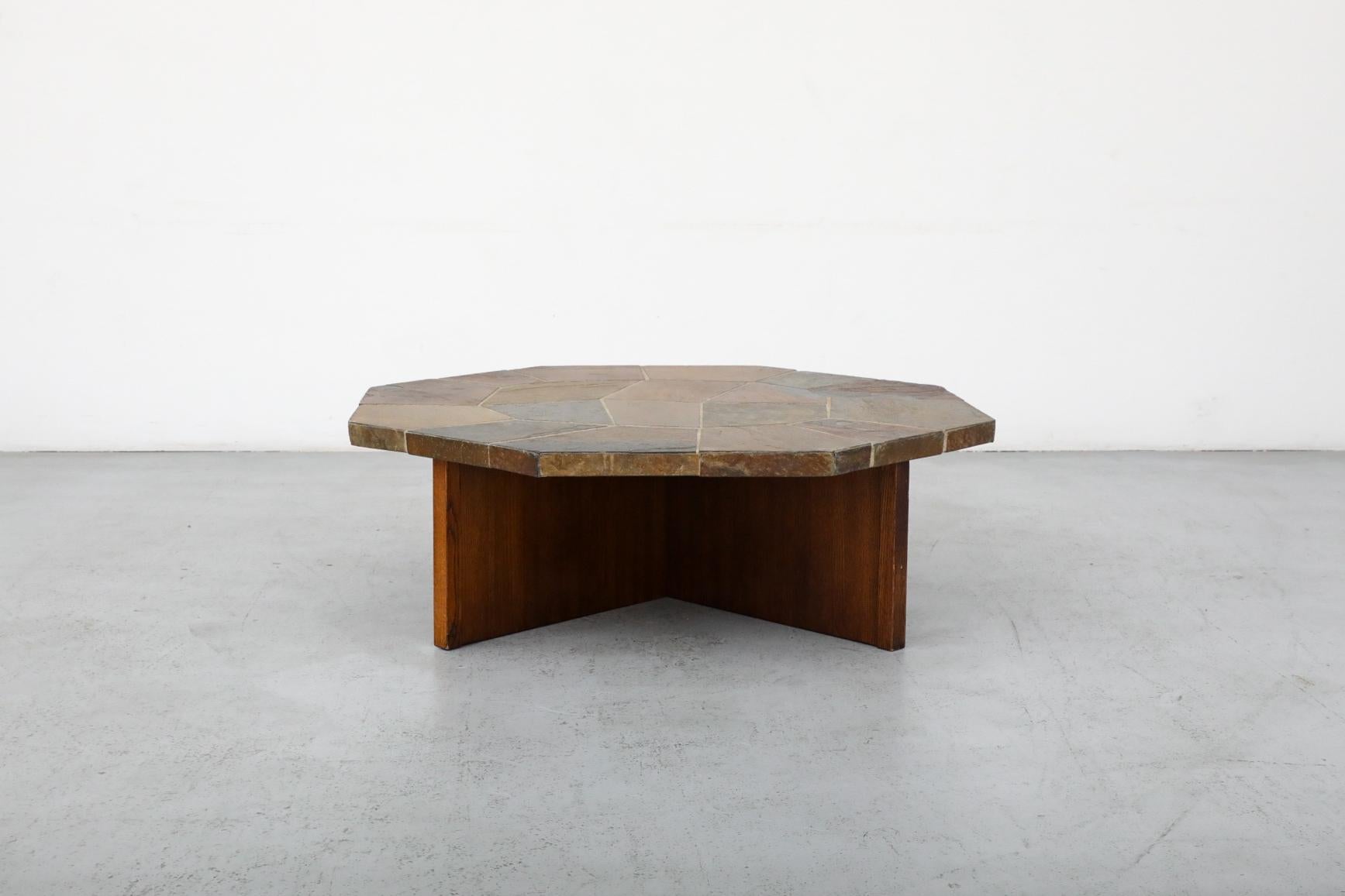 Paul Kingma Style stone mosaic coffee table with wooden X base. Lightly refinished base with top in original condition with visible wear, including chipping and scratching. Wear is consistent with its age and use. Other similar stone tables are