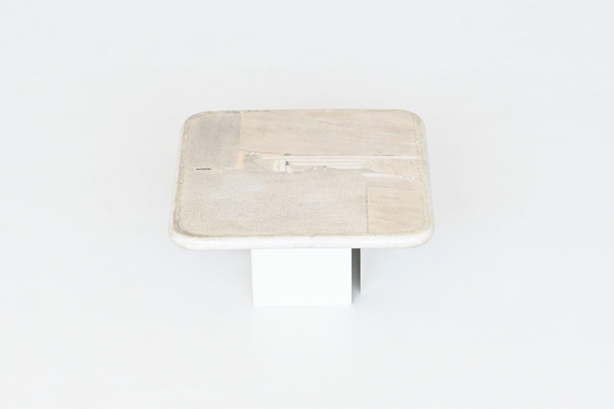 Beautiful square shaped coffee table designed and made by Marcus Kingma, The Netherlands 1988. The heavy white concrete top rests on a base of two off white lacquered metal bases that can be placed in several positions. Beautiful composition of