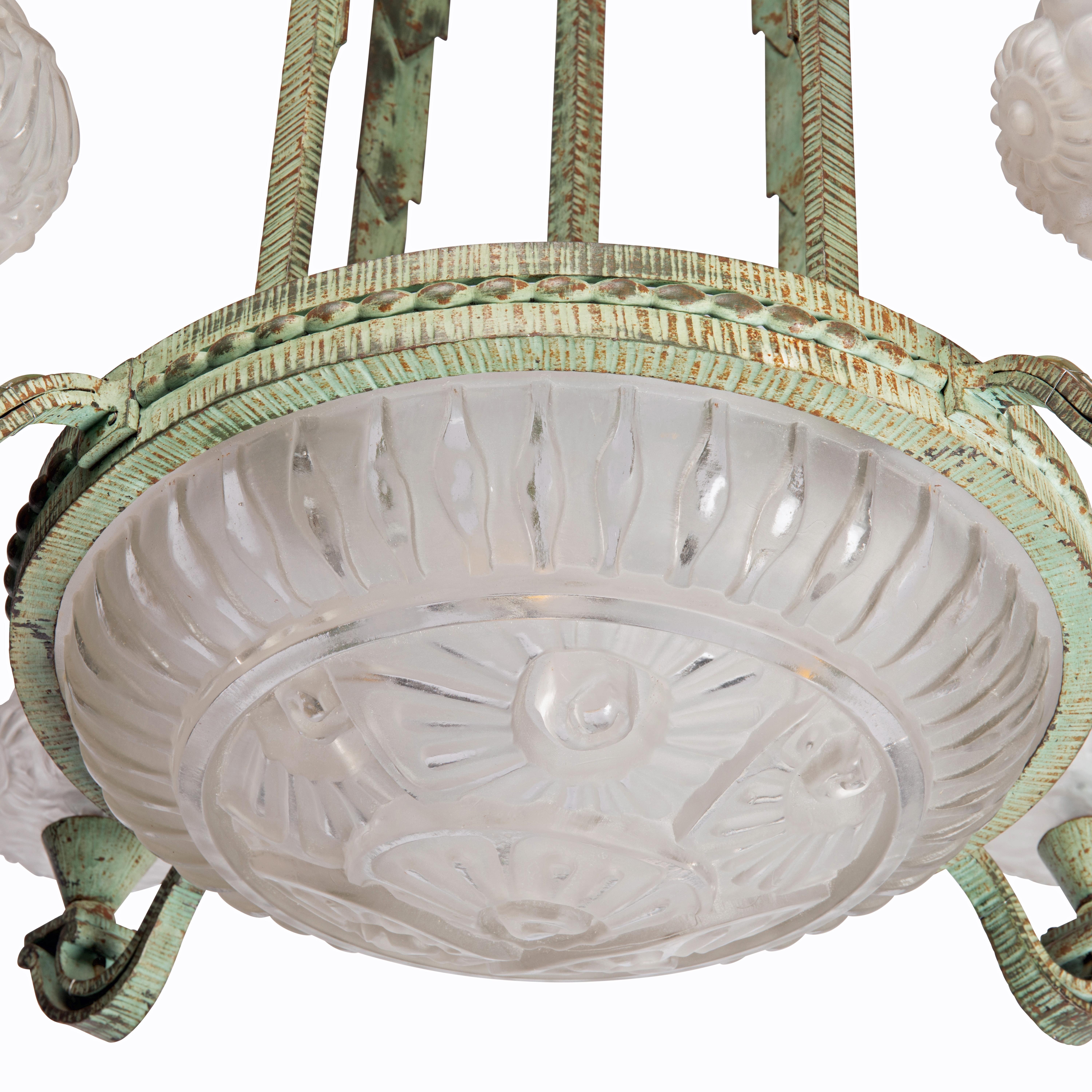 Beautiful Circular Art Deco chandelier, in Patinated Cast Iron attributed to Paul Kiss, and Pressed and Molded Glass by Genet & Michon.

The chandelier is in the shape of a skyscraper, or a cascading fountain and the wrought iron has the original