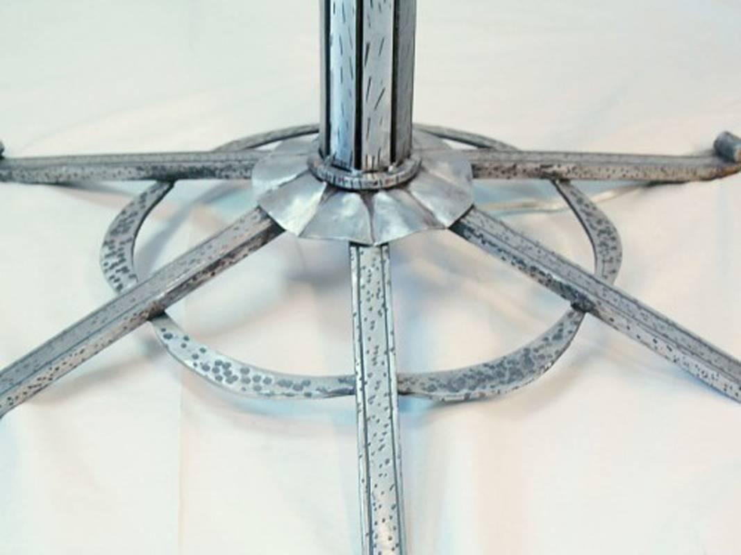 Torchiere floor lamp in the style of “Paul Kiss” hand forged mild steel hammered metal finish with clear coating and alabaster shade.

Dimensions: 72 ht x 25.5 diameter shade.