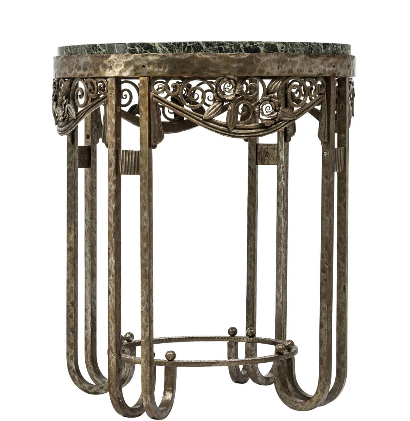 Stamped P. Kiss, Paris. A rare wrought iron and green marble round top console side table in exceptional condition with foliage and flower decorated aprons, circa 1930.

Measures: Height 24 inches
Diameter 20.5 inches.

Paul Kiss was a French artist