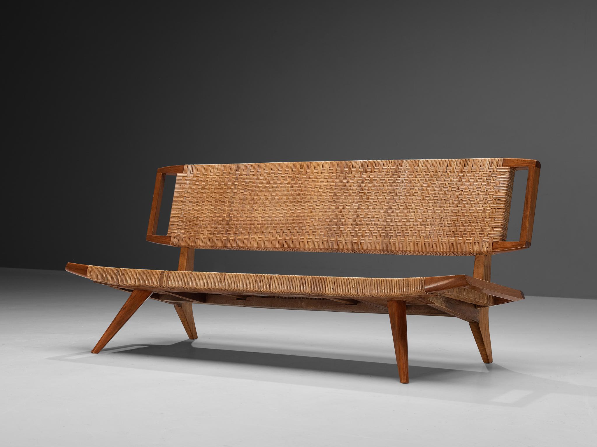 Paul László for Glenn of California, bench or sofa, mahogany, cane, United States, 1950

This sofa or bench, a creation of Paul László, contains a well-preserved caned back and seat. The sofa's legs gracefully angle outward, accentuating their