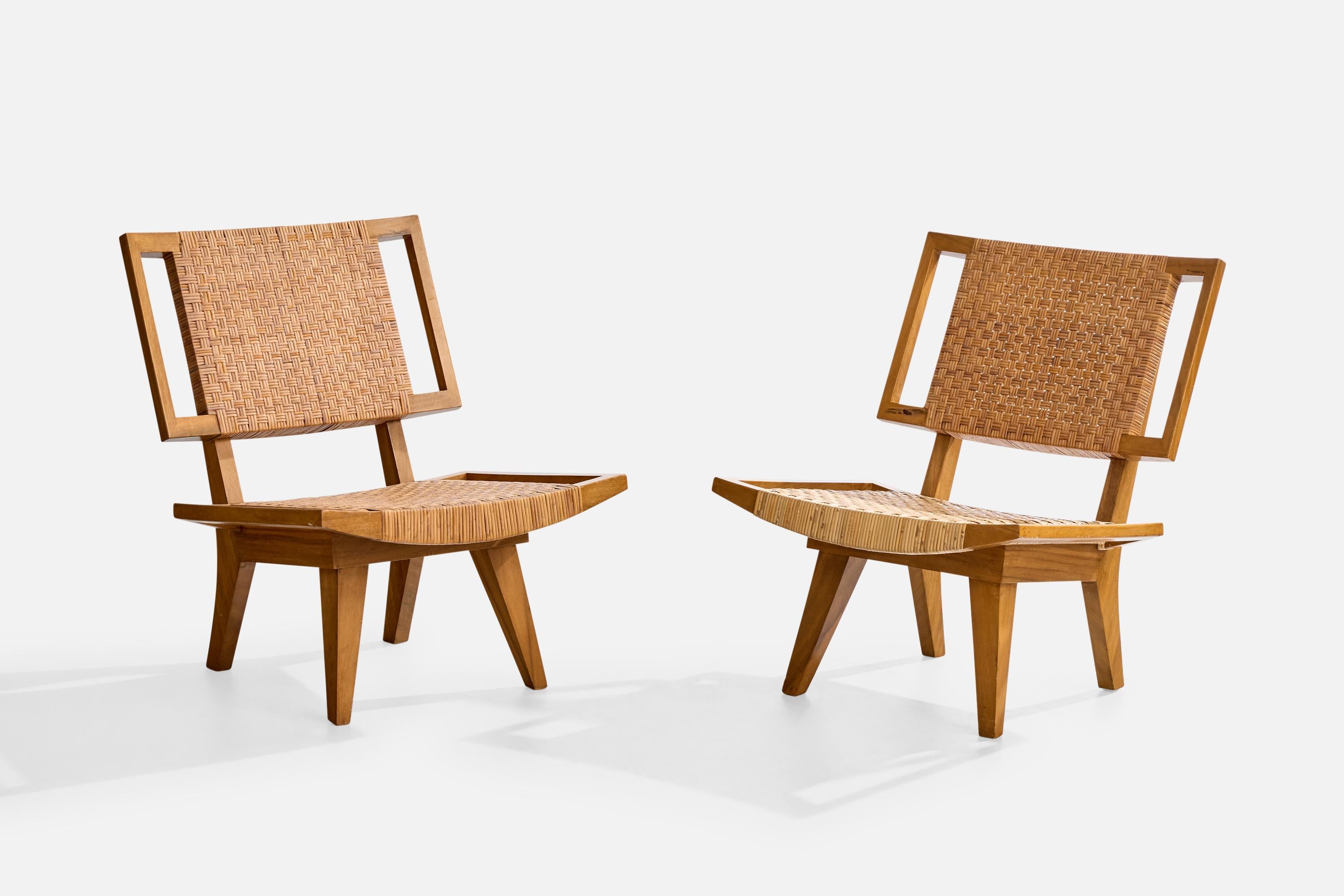 A pair of bleached mahogany and rattan lounge chairs attributed to Paul Laszlo for Glenn of California, USA, c. 1950s.

Loss to rattan straw as illustrated.

Overall Dimensions (inches): 31.375