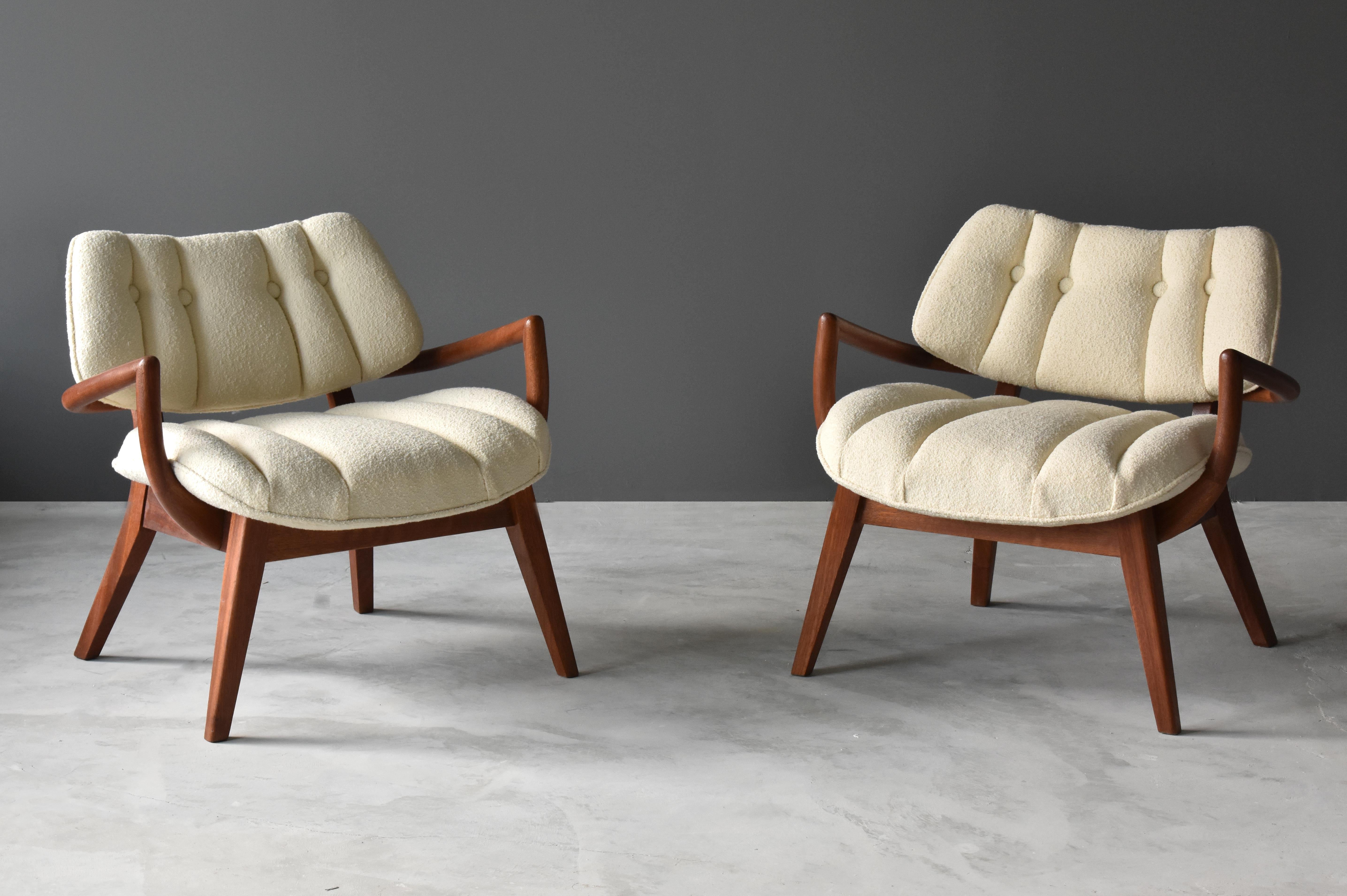 A pair of modernist lounge chairs attributed to Paul László. Soft and tufted overstuffed seat and back is mounted on stained mahogany frames with splayed legs. 

Other American designers include Paul Frankl, Edward Wormley, George Nakashima, Isamu