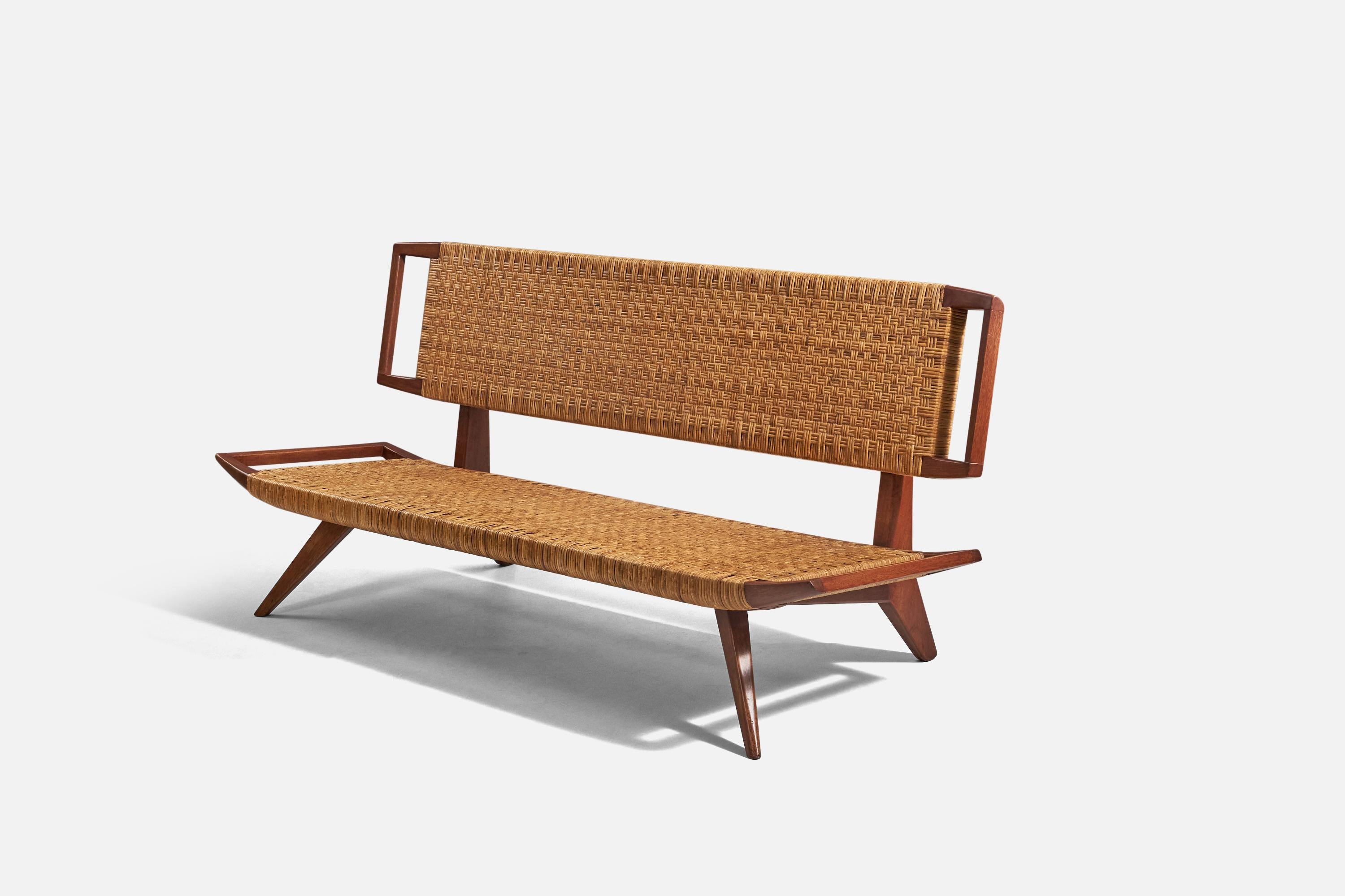 A mahogany and rattan bench designed by Paul László and produced by Glenn of California, USA, 1950s.