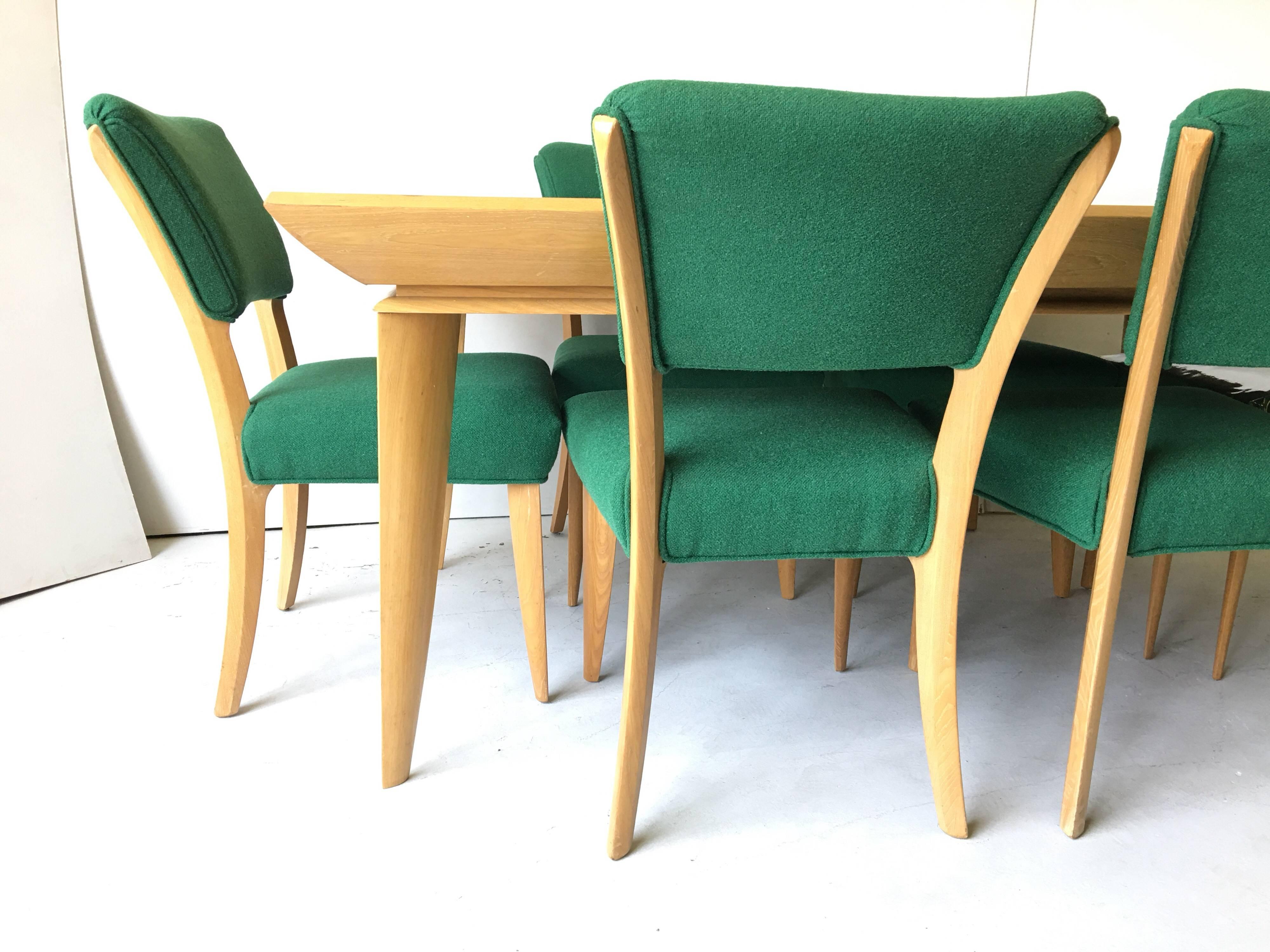 Fantastic Laszlo design! This table, although midcentury, has an Art Deco look, with extreme bevel edge, and tapering knife-edge legs! It is wonderful! It has a beautiful grainy oak top with two accompanying leaves. There are a set of six chairs in