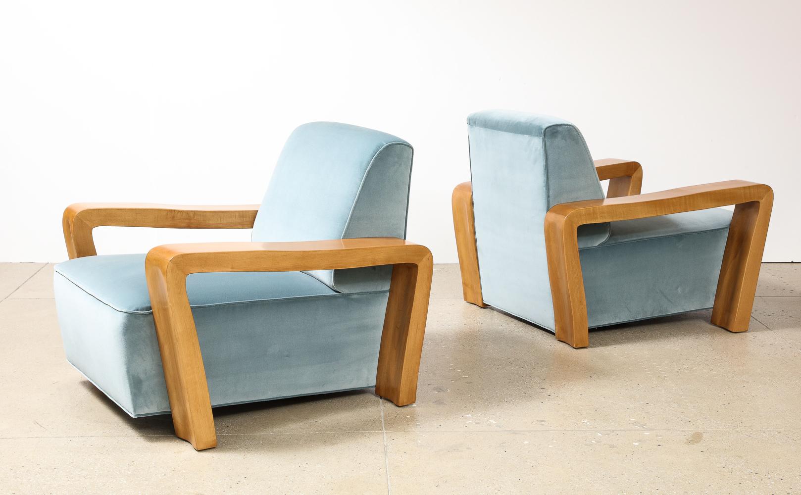 Rare Pair of Club Chairs by Paul László. Maple wood, velvet upholstery. Massively scaled & sculpted side supports of light wood. Deep cushion seats that appear to float just above the floor. A rare model.