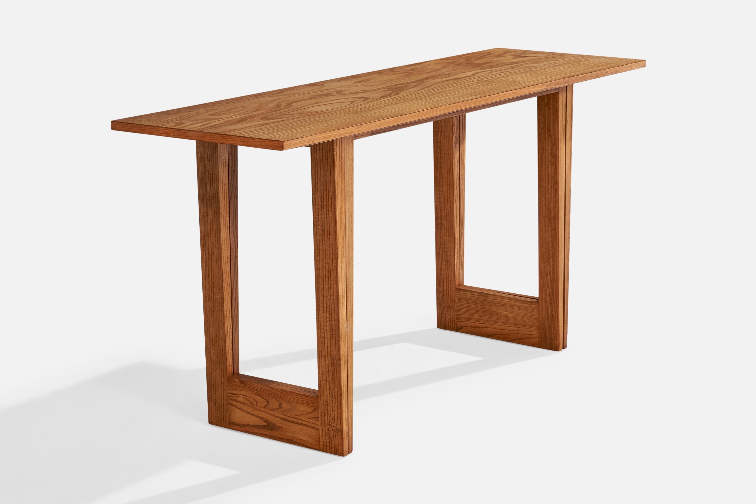An oak console table designed designed by Paul Laszlo and produced by Brown Saltman, USA, 1950s.





 

Table originally configured as flip-top console, present table is missing one leaf and only functions as console table.





Dimensions: 29.25”