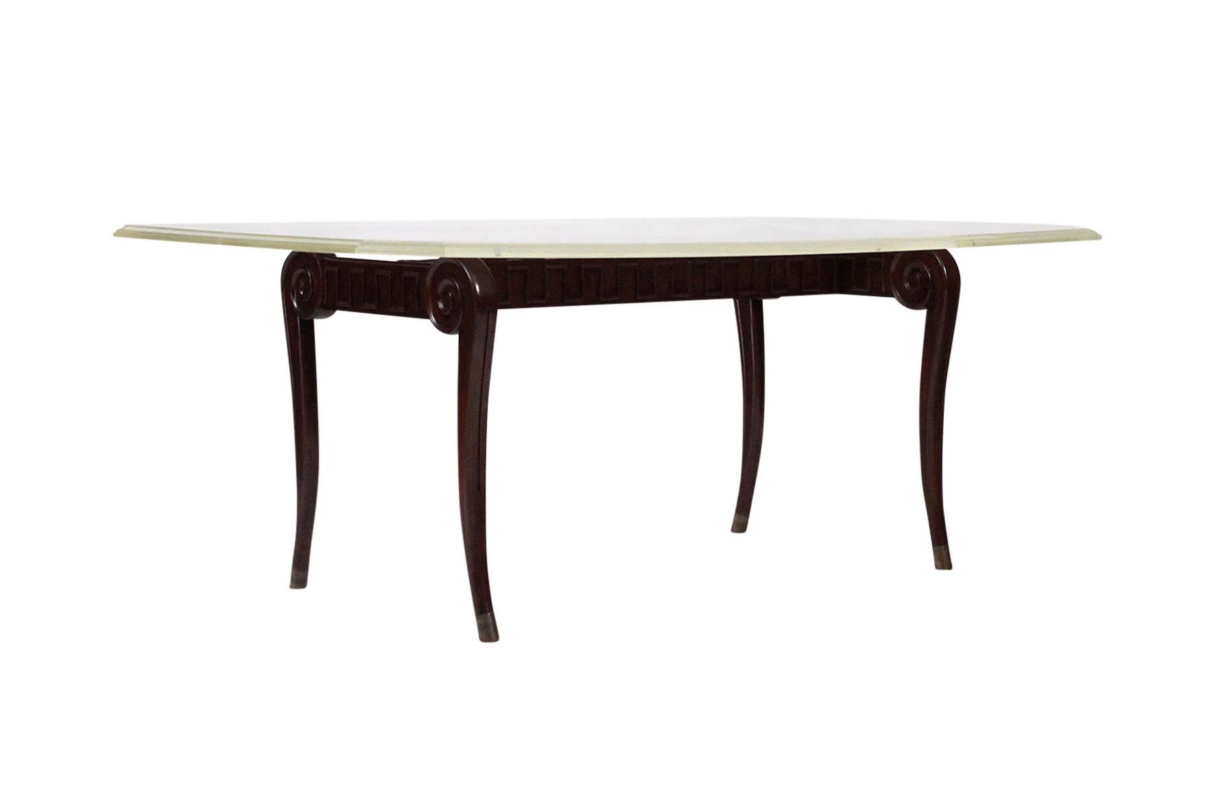 Dining table with beautifully carved base and beveled-edge Lucite top by Paul Laszlo.