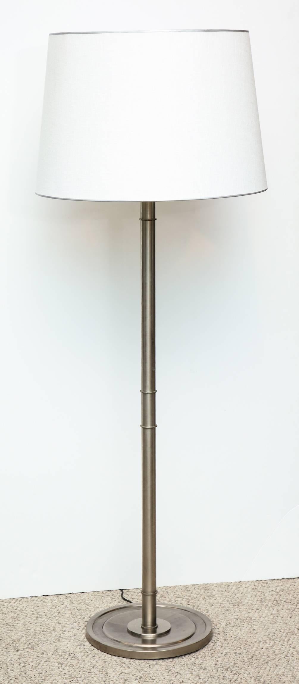 Custom designed floor lamp by Paul László. Pole lamp of oxidized nickel with great detailing and new linen shade. Three standard sized sockets and one large up light that takes a three -way bulb. All sockets and wiring have been recently replaced.