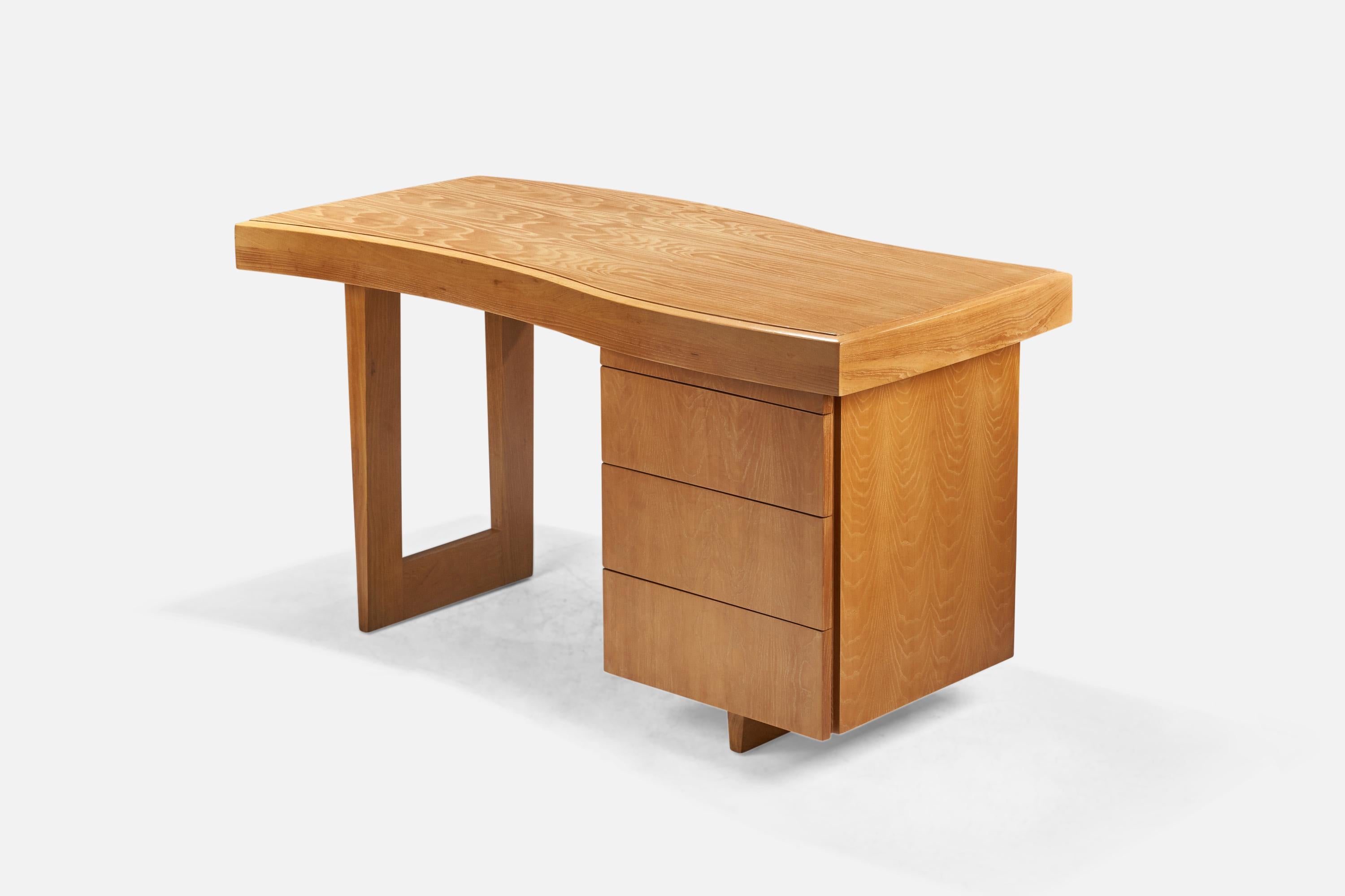 A freeform oak desk designed by Paul Laszlo and produced by Brown Saltman, USA, 1940s.