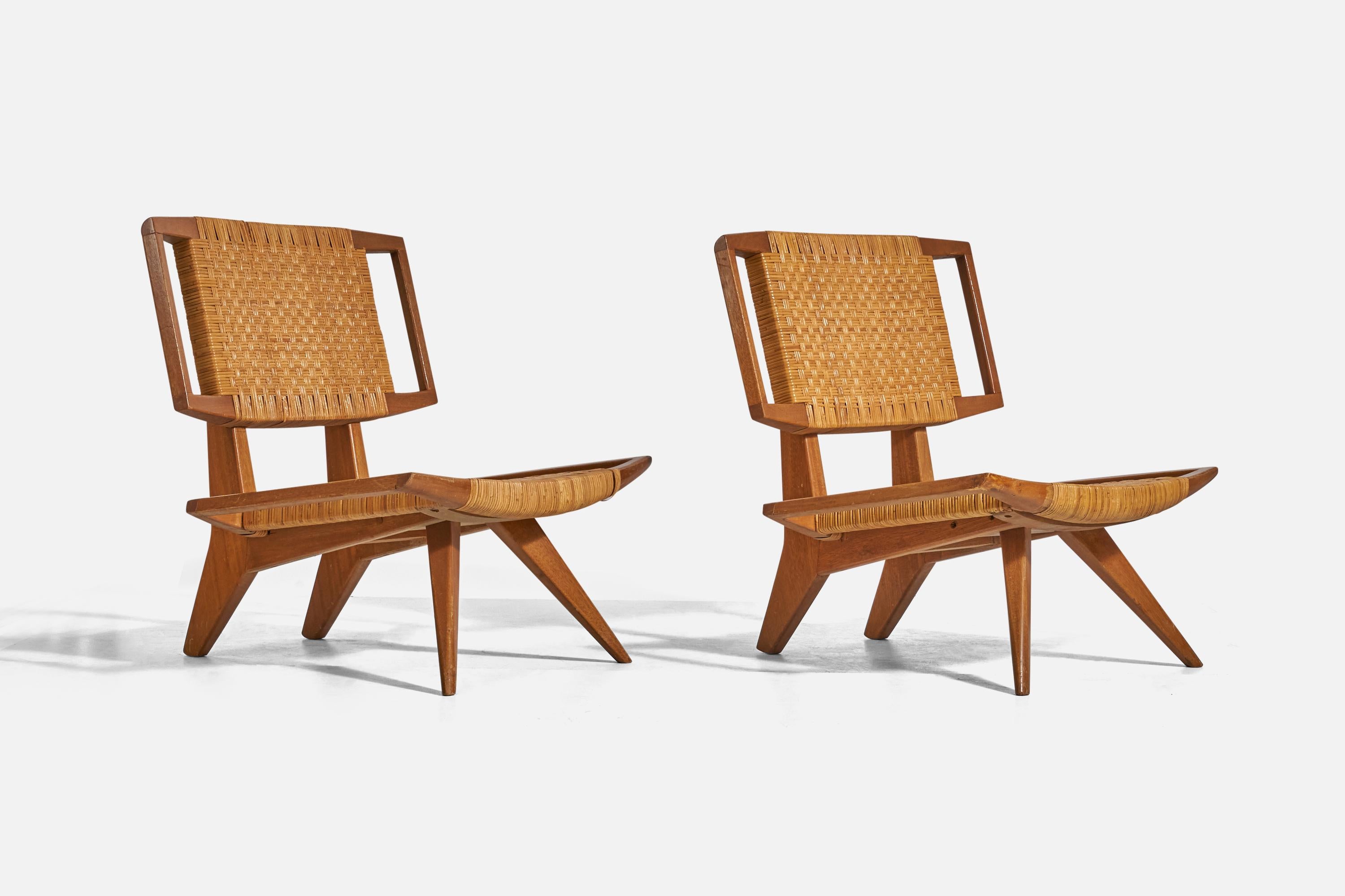 A pair of rattan and mahogany lounge chairs designed by Paul László and produced by Glenn of California, United States, 1950s. 

