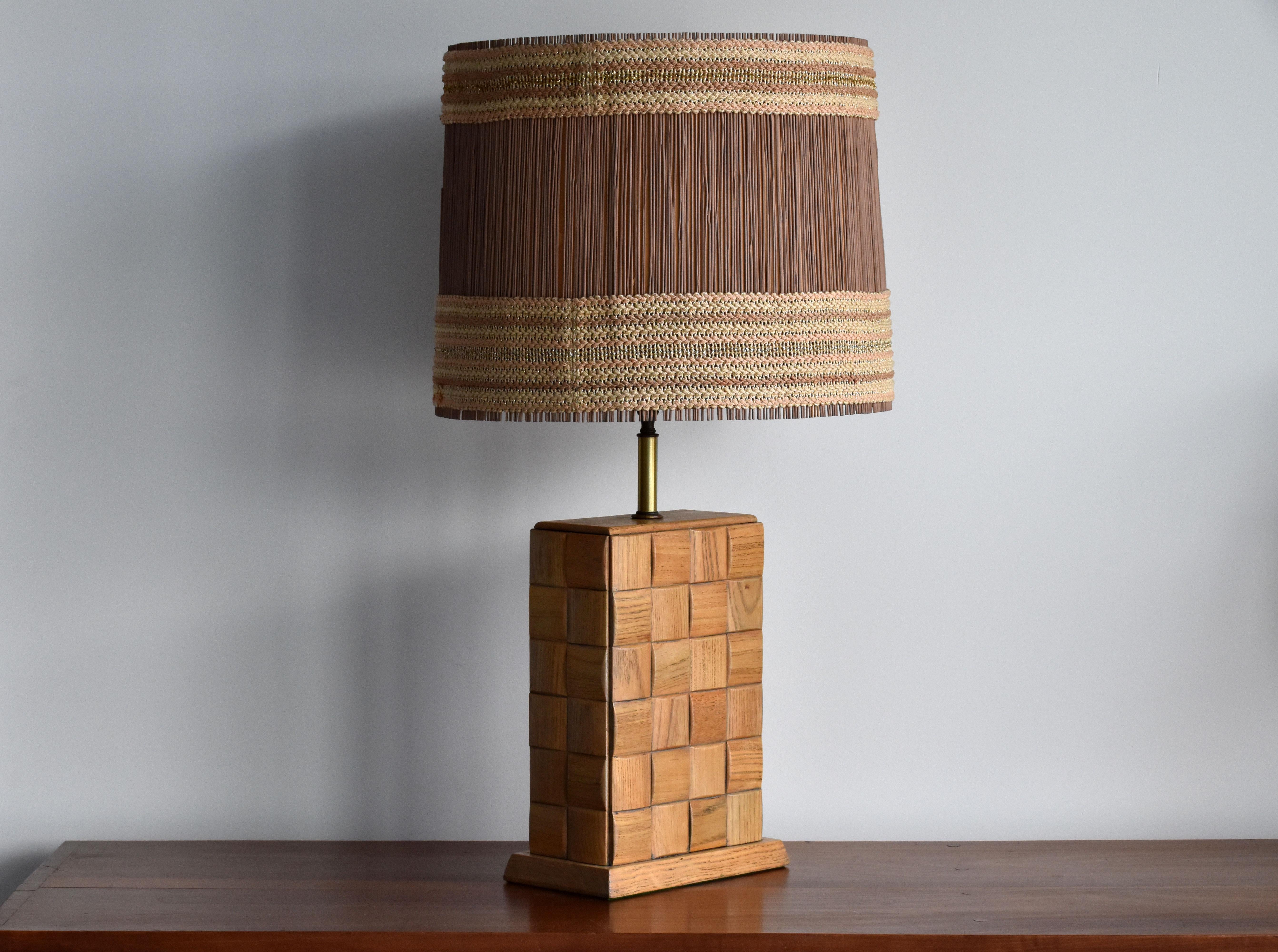 A large modernist table lamp by Paul Laszlo, fitted with a Maria Kipp shade (most likely secondary to lamp). It was produced by Brown Saltman. 

The base features Laszlo's iconic chess pattern that was incorporated in his designs for Brown Saltman.
